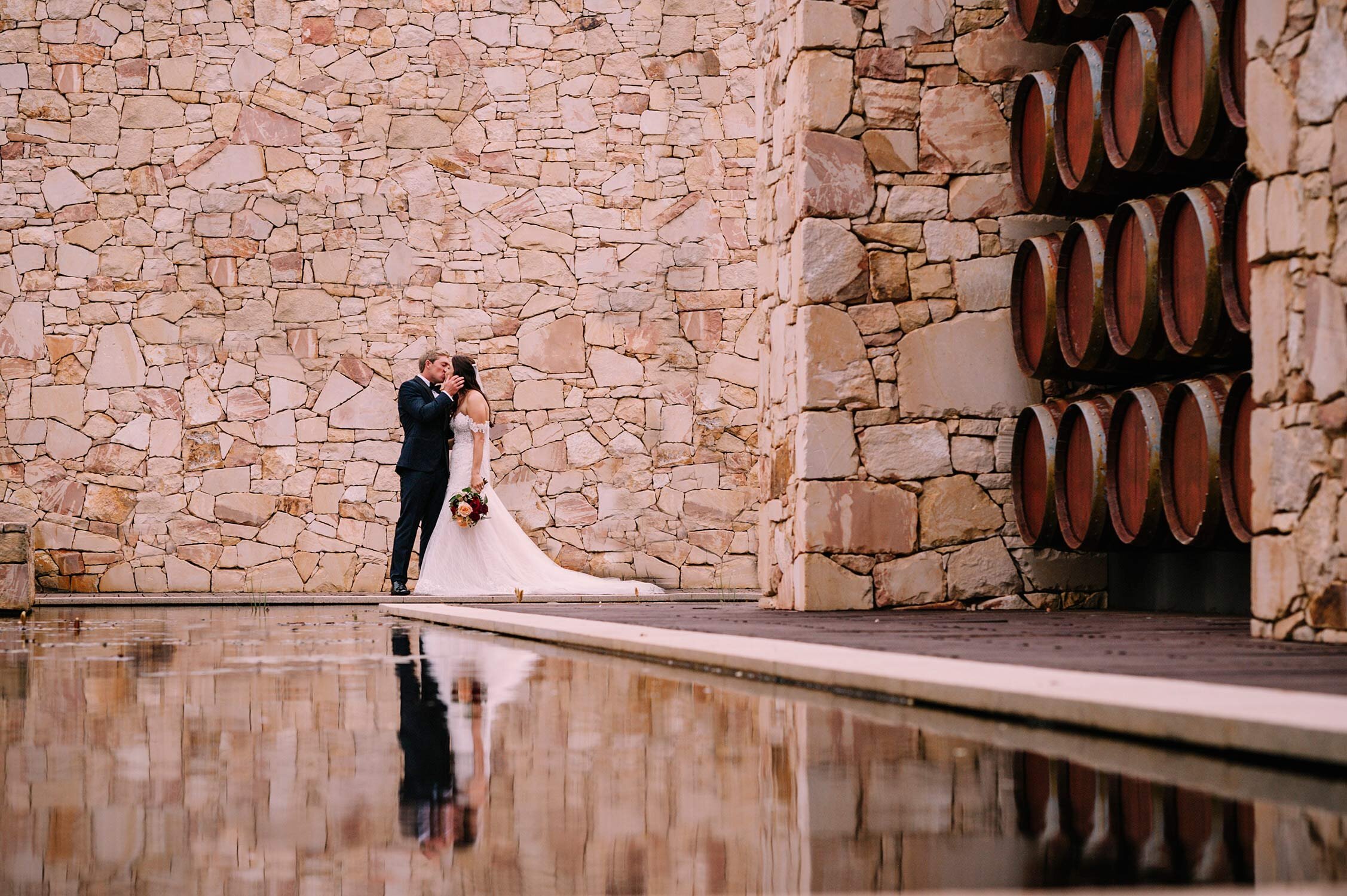 amazing-water-reflection-photo-of-groom-kissing-bride-at-caves-road-collective-in-margaret-river.jpg
