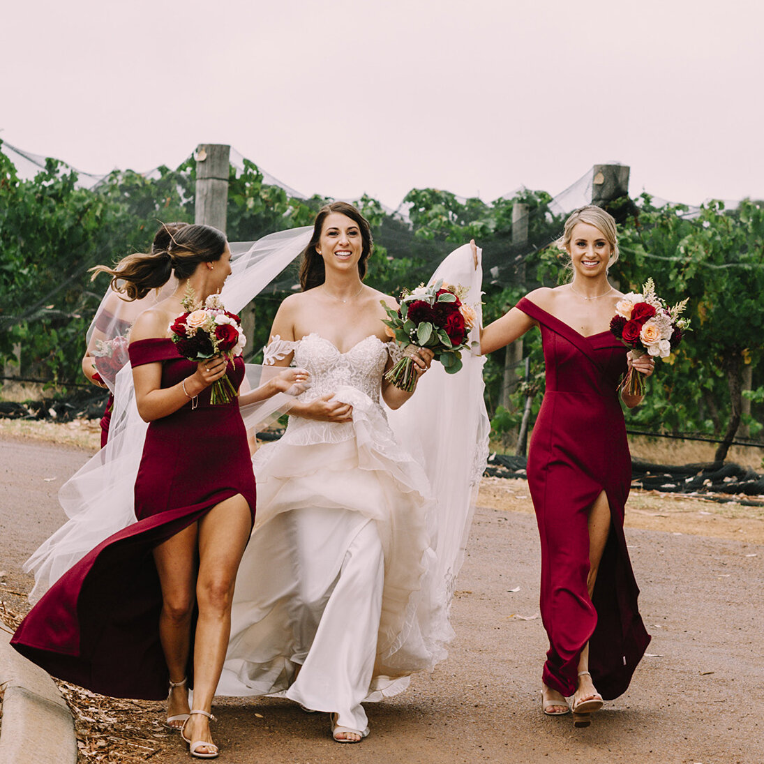 amazing natural portrait of bride, bridesmaids and her father walking to her wedding at caves road collective in margaret river.jpg
