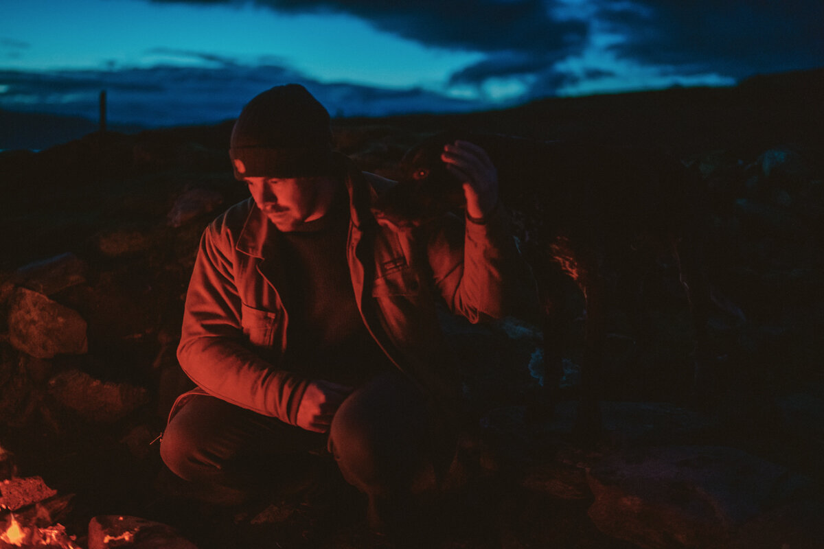  stevie weir st andrews wedding photographer sitting at campfire on dark night  