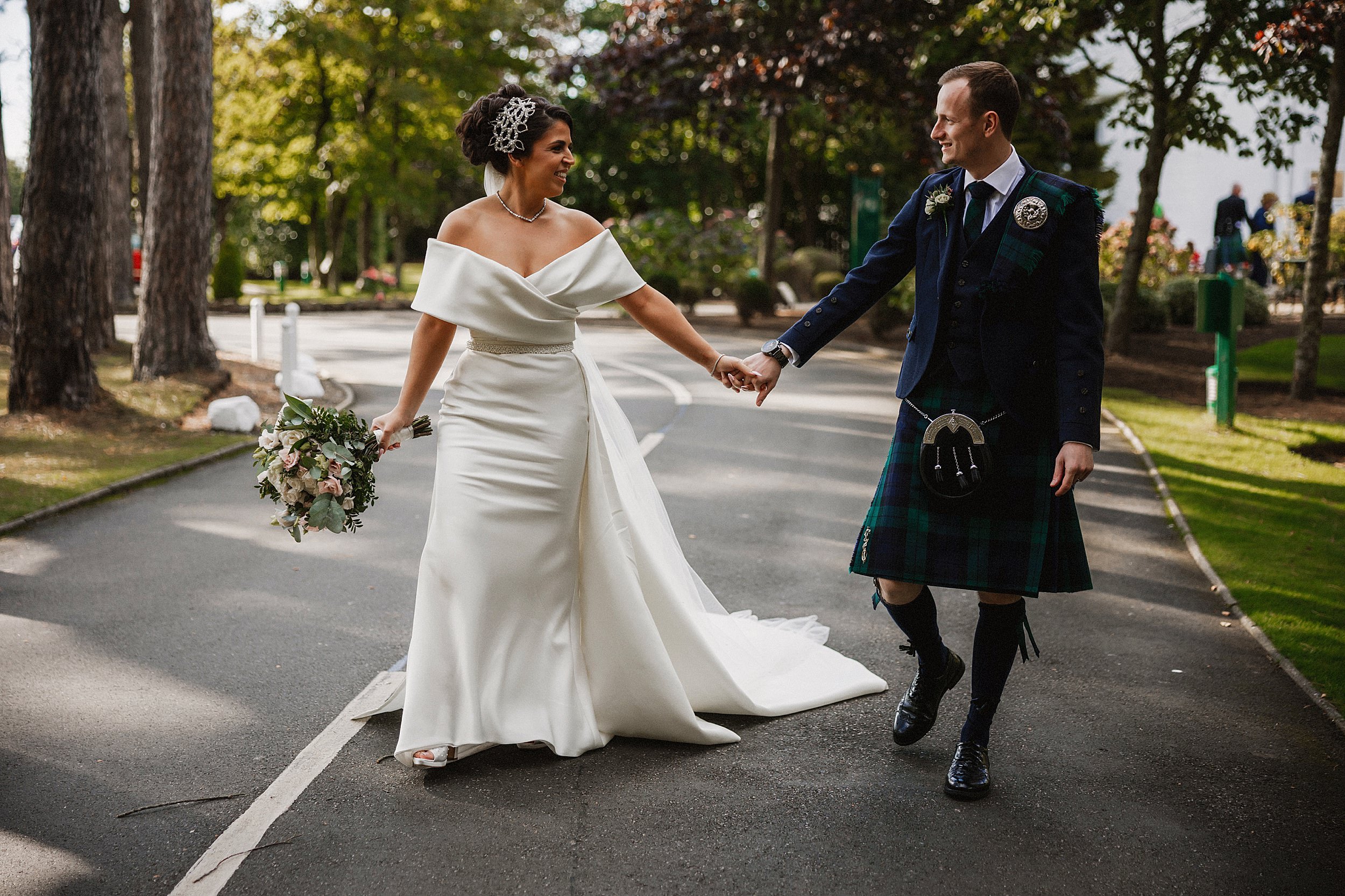 Bride and groom walking in the grounds of Lochgreen House Hotel on their wedding day