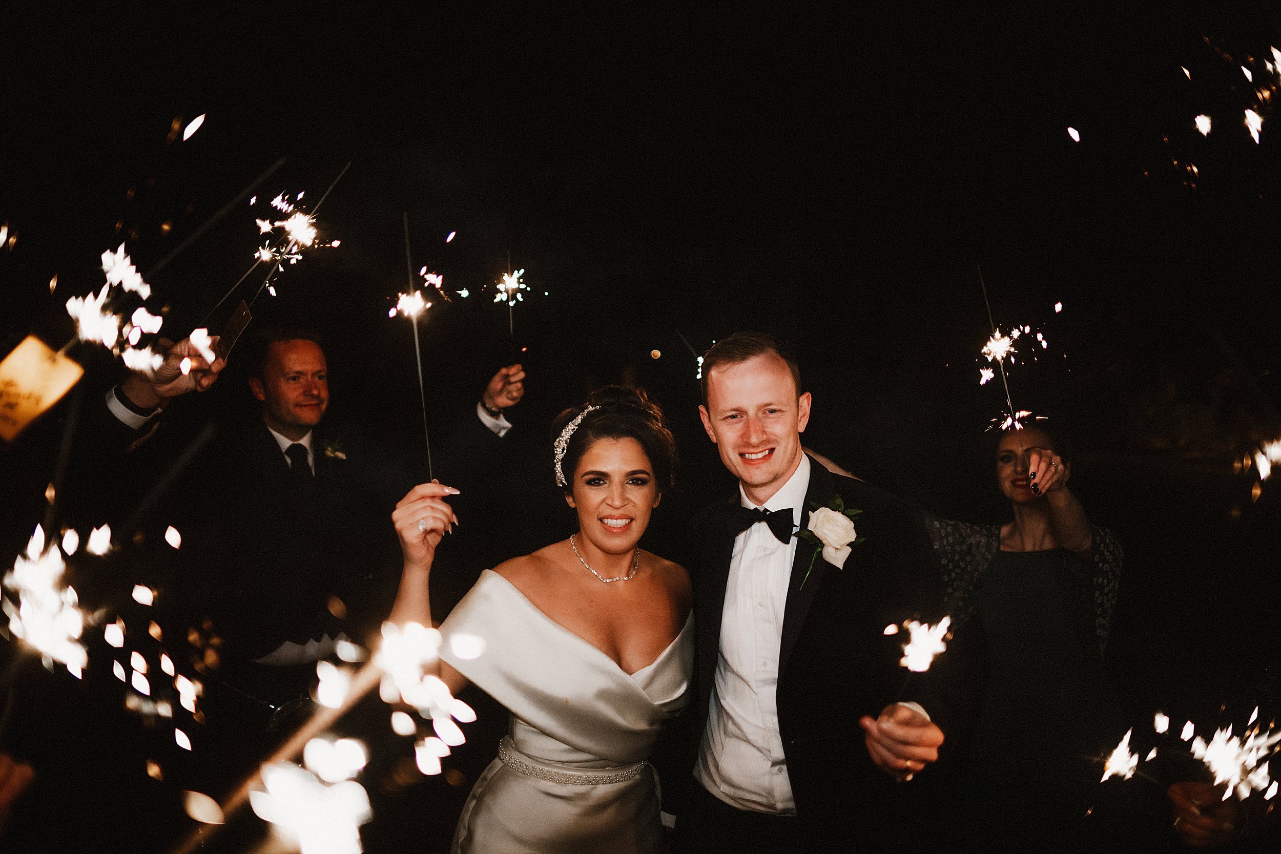 Wedding couple with their guests and sparklers at Lochgreen House Hotel