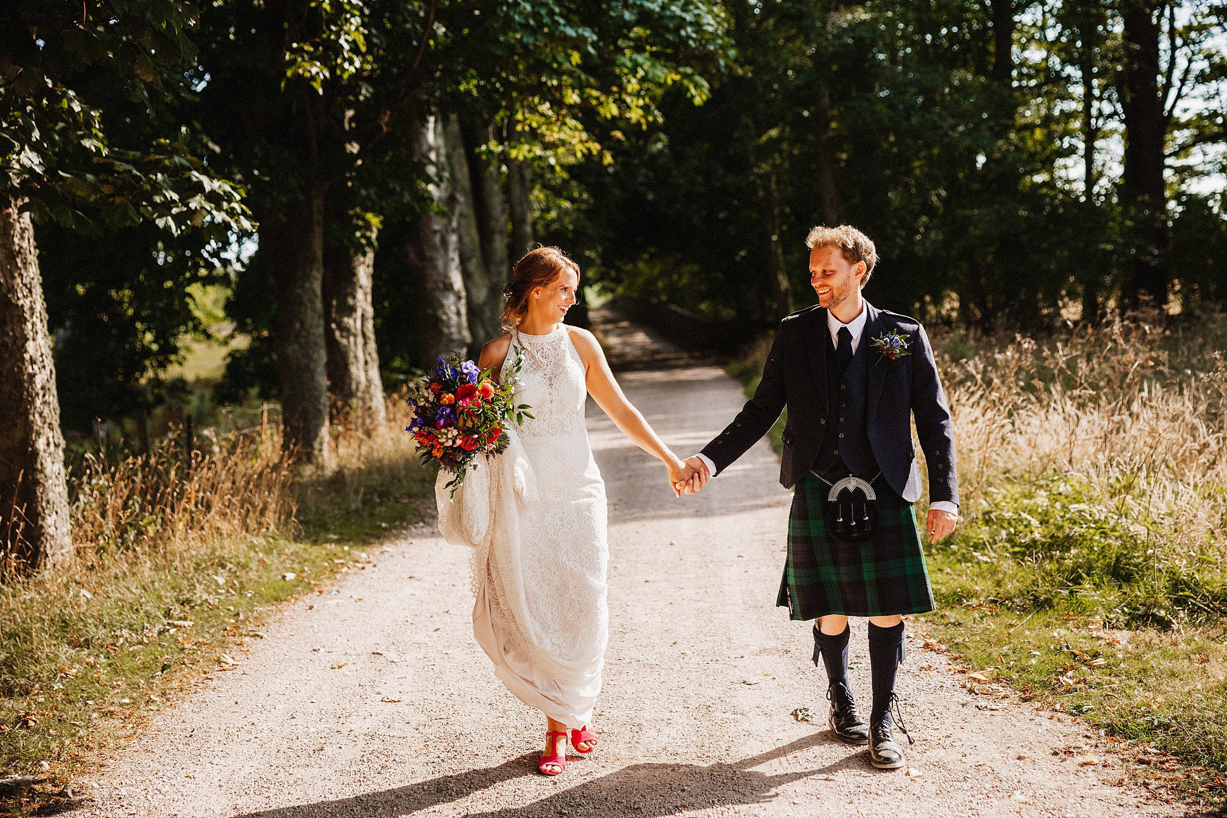 Couple walking on their wedding day at Kinkell Byre in St Andrews