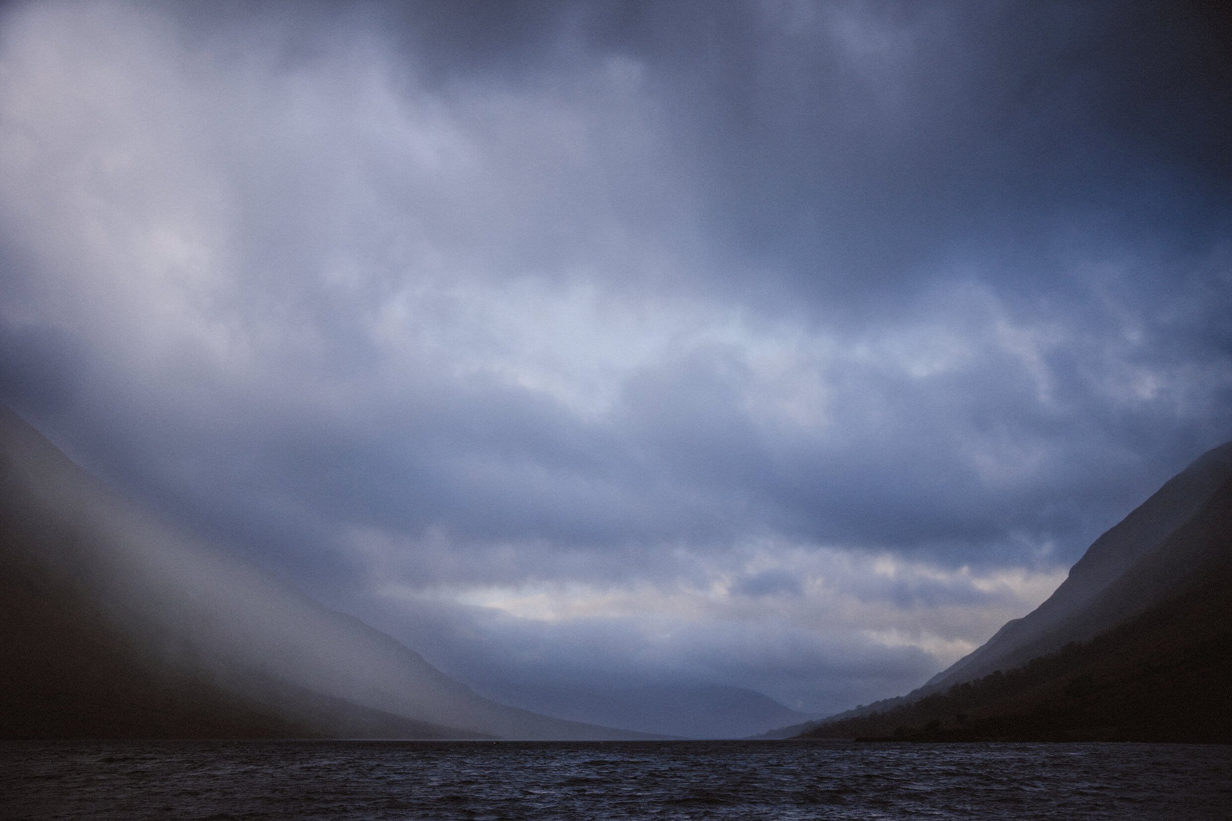 loch etive with a dramatic stormy sky and rain blowing in