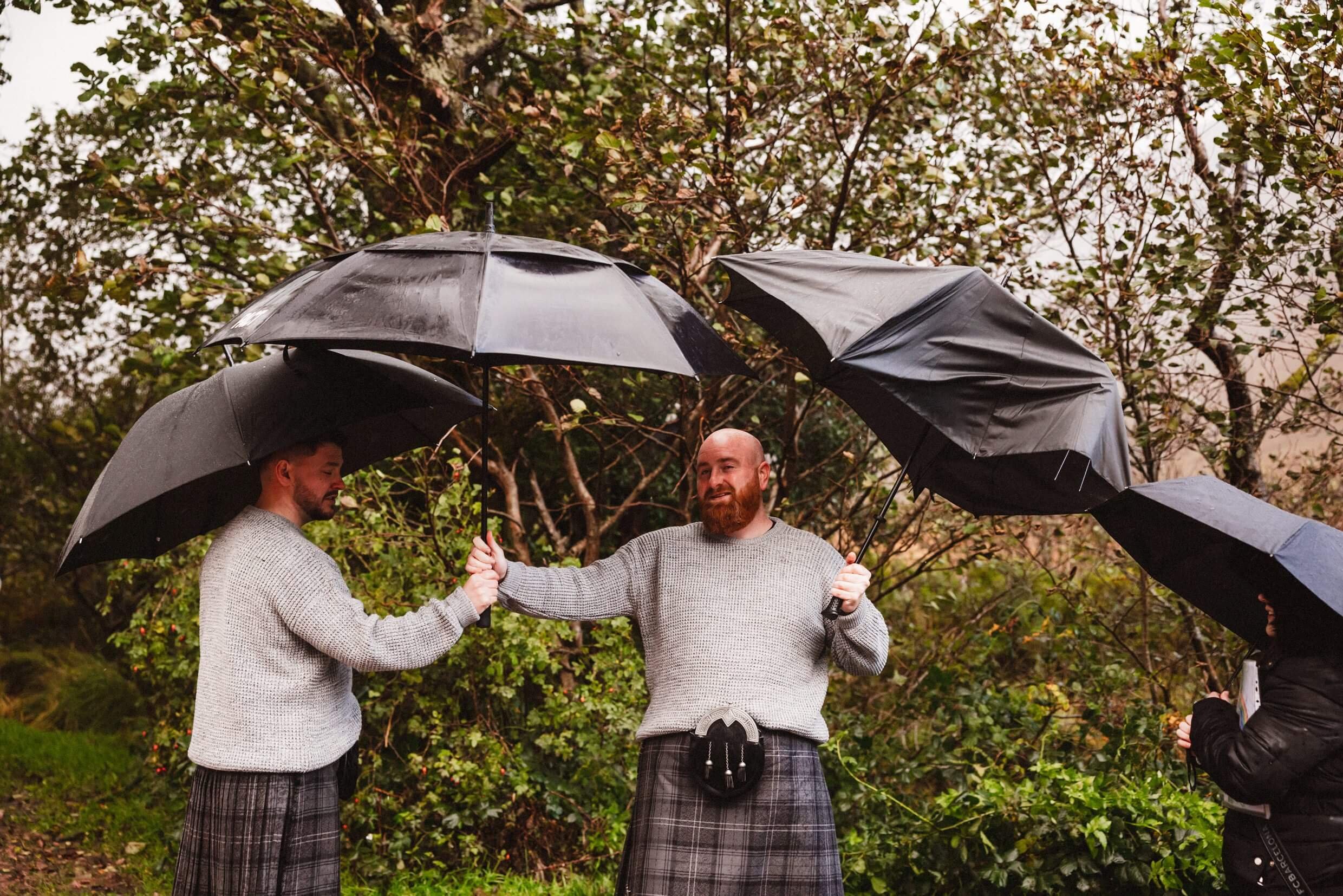 guests with umbrellas during scottish glencoe elopement