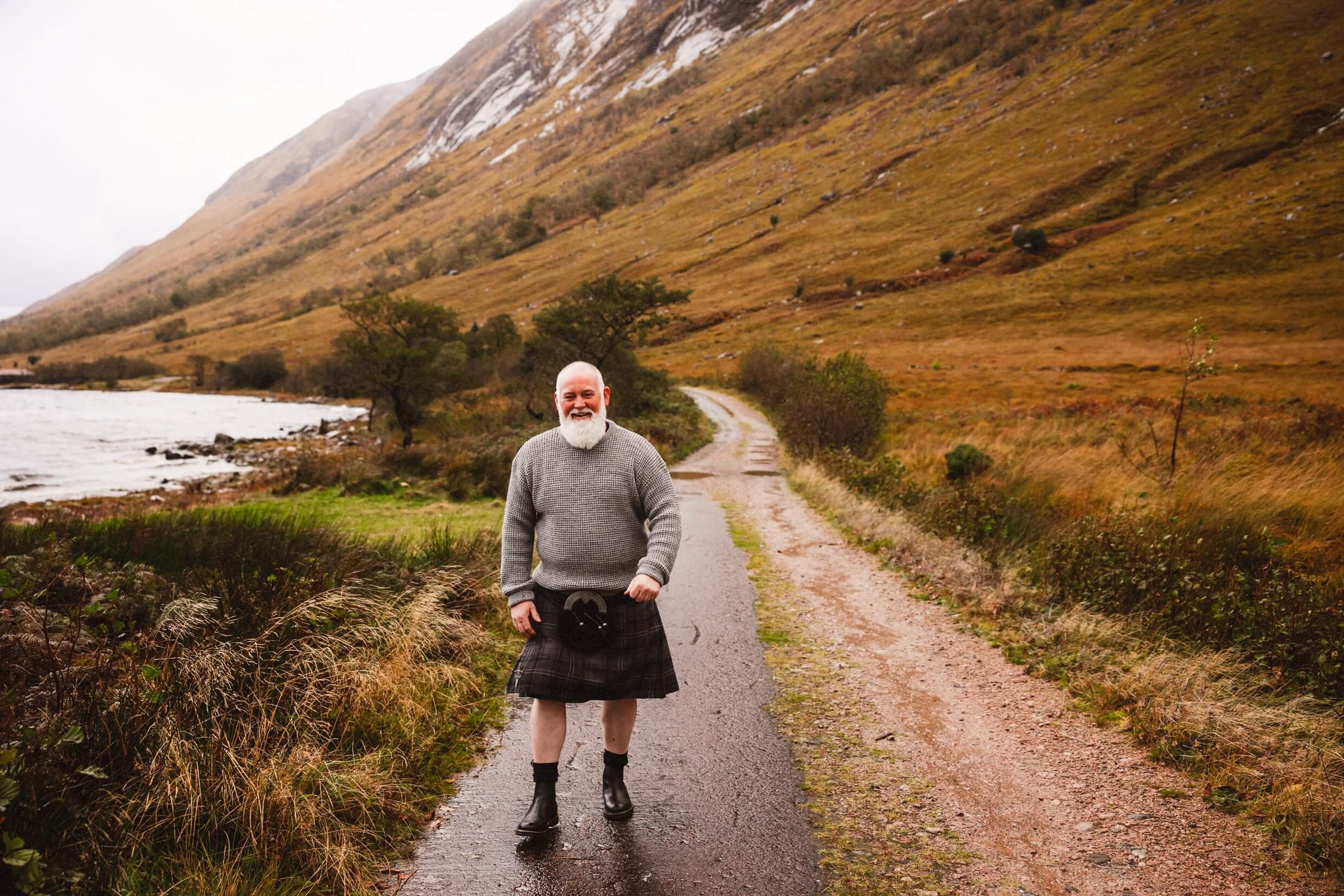 father of the bride wearing a kilt with glen etive in background during glencoe elopement in scotland