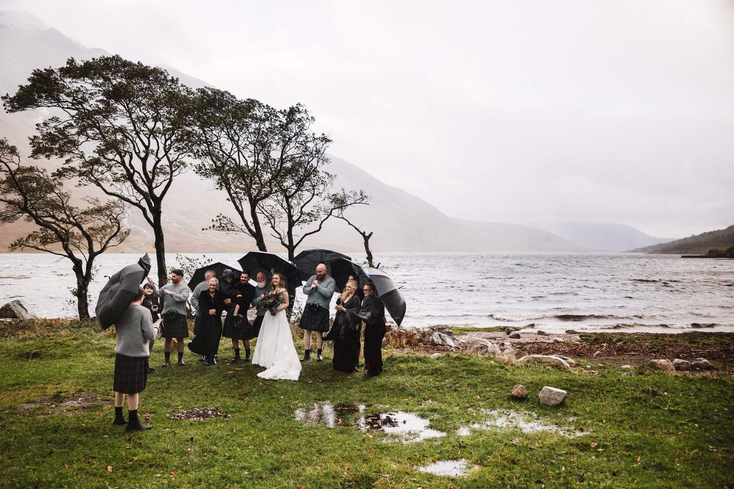 outdoor wedding ceremony in the rain at loch etive during glencoe elopement in scotland