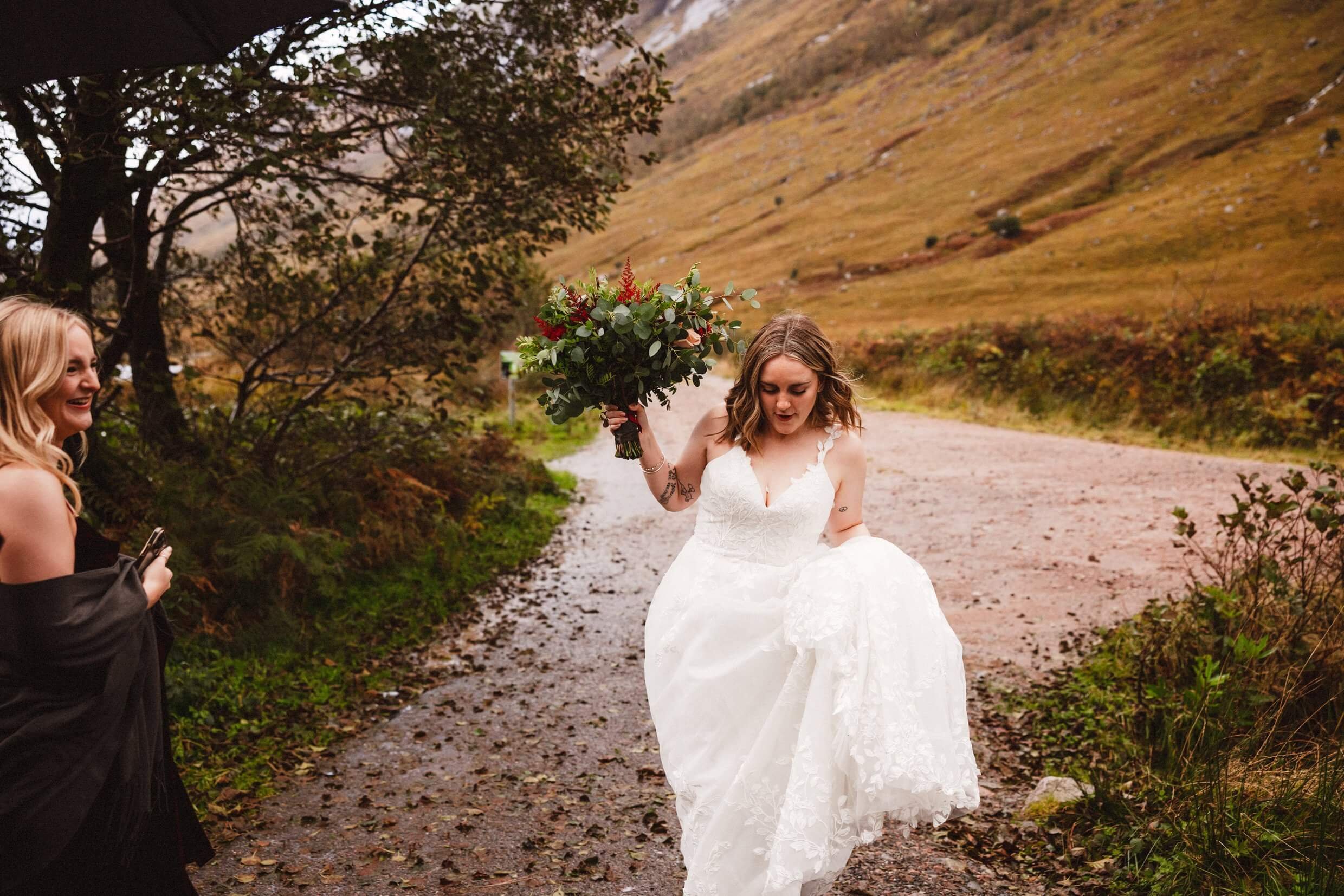 bride holds bouquet of flowers in glen etive during glencoe elopement in scotland