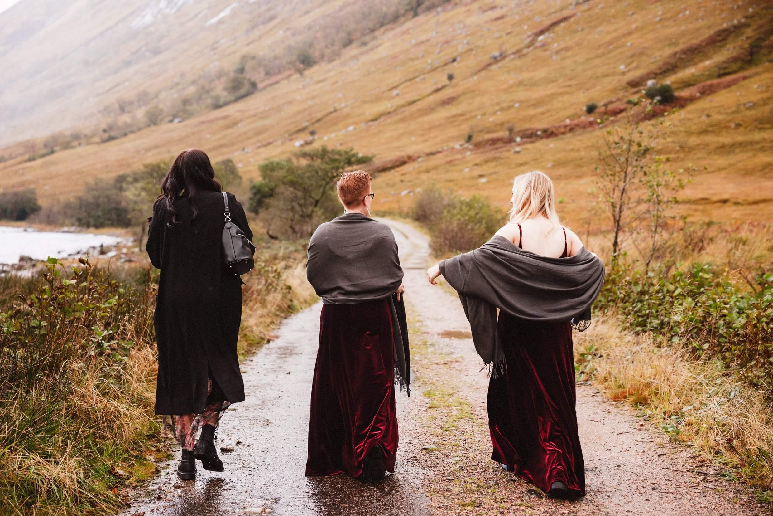 bridesmaids in red velvet dresses in scottish highlands glencoe elopement