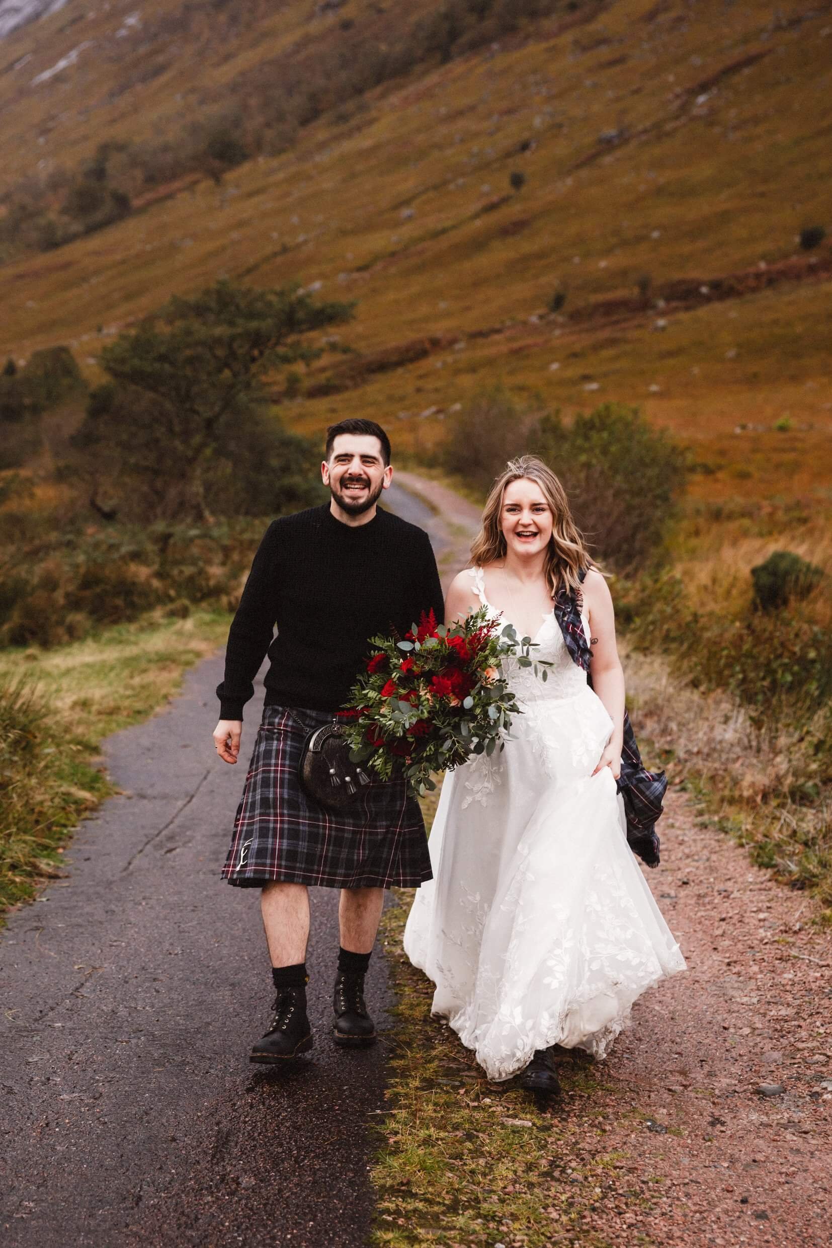 bride and groom walking in glen etive during glencoe elopement in scotland