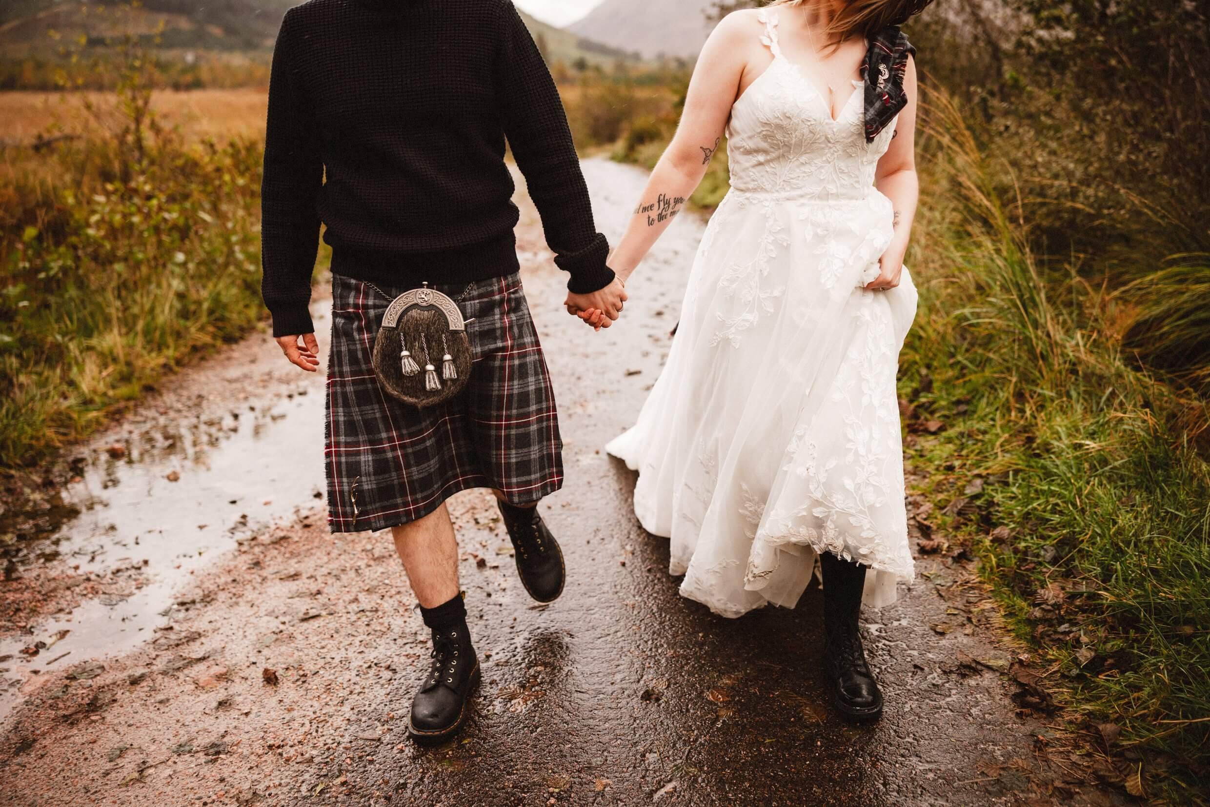 bride and groom holding hands in glen etive during glencoe elopement in scotland