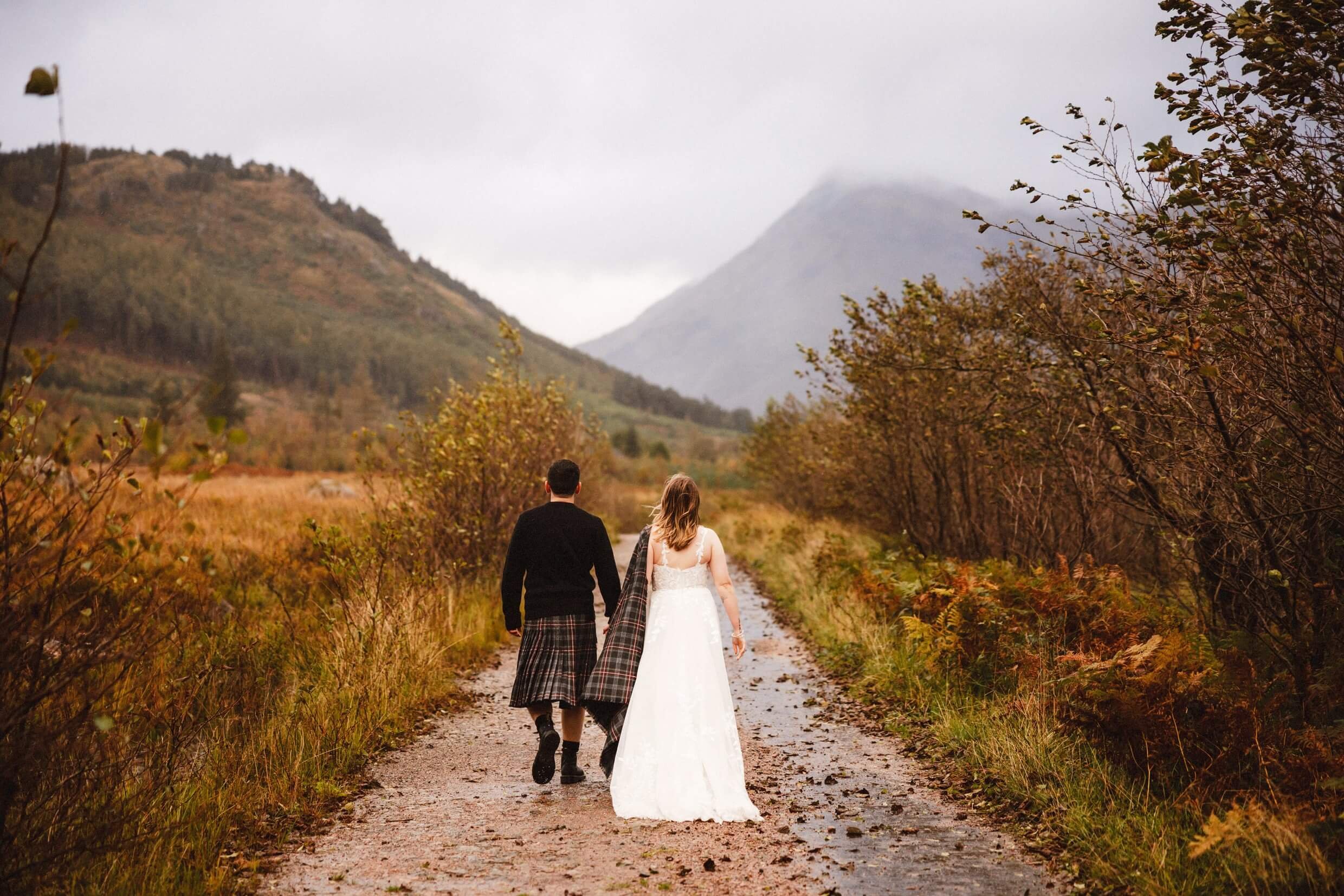 bride and groom seen from behind during glencoe elopement in glen etive in scotland
