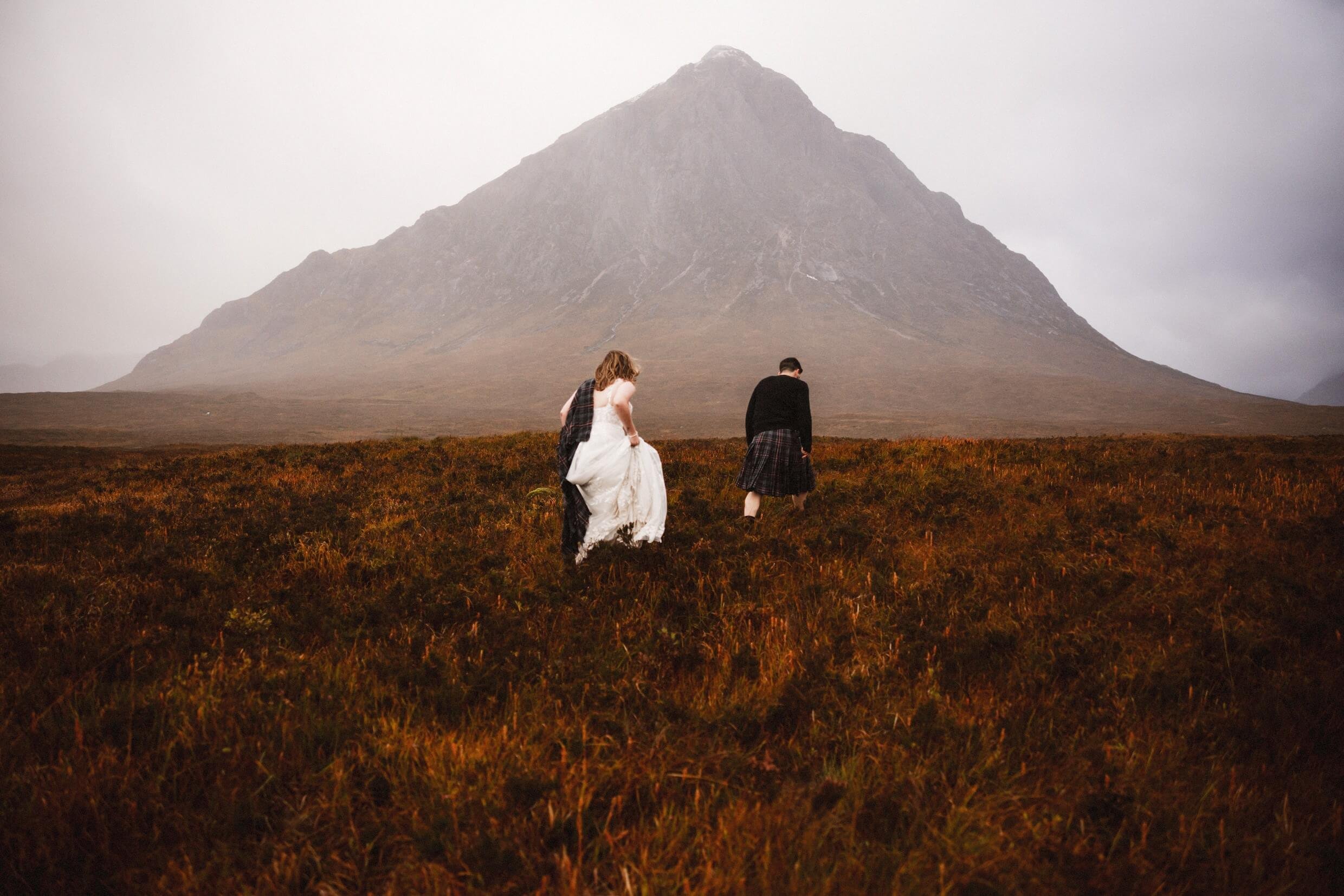 bride and groom walk through glen coe during glencoe elopement