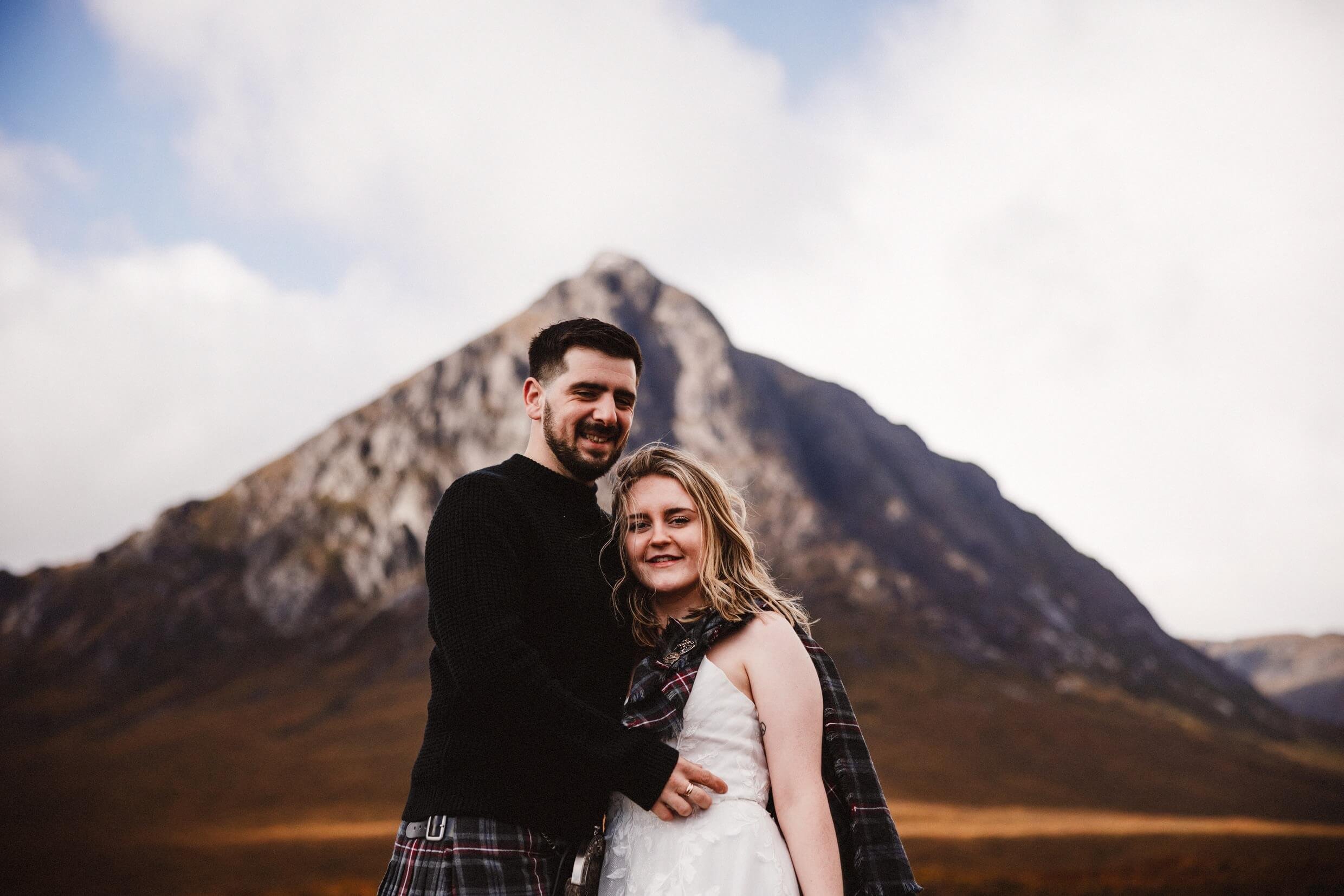 bride and groom stand in front of stob dearg mountain during glencoe elopement