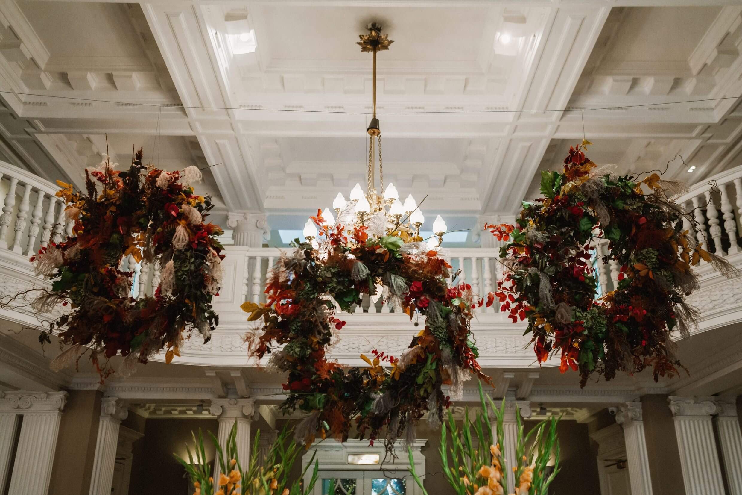 inside interior view of the balmoral hotel edinburgh wedding venue showing greenery wreaths hanging from the ceiling