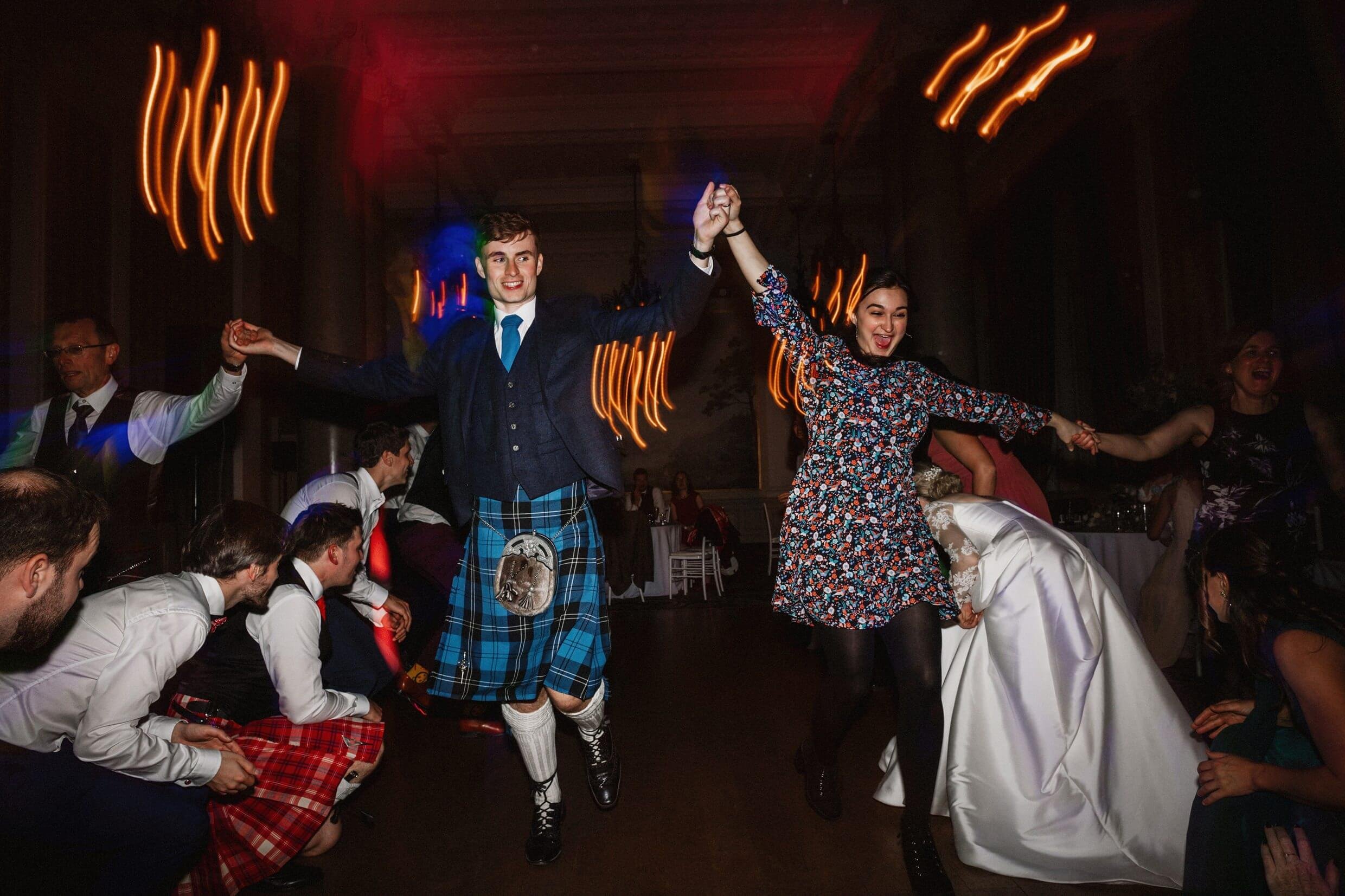 the wedding party ceilidh dancing at the balmoral hotel edinburgh wedding venue in scotland