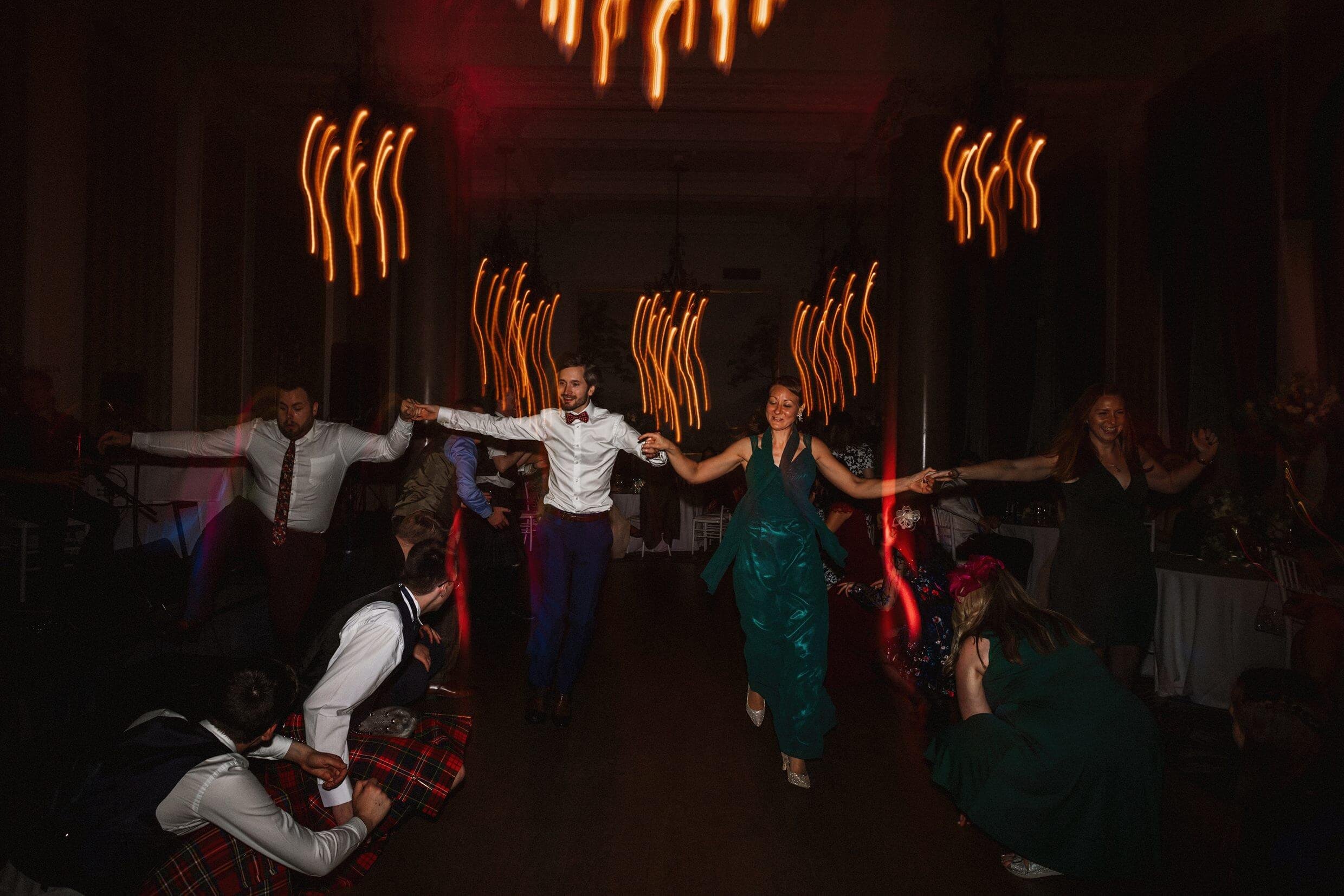 the wedding party ceilidh dancing at the balmoral hotel edinburgh wedding venue in scotland