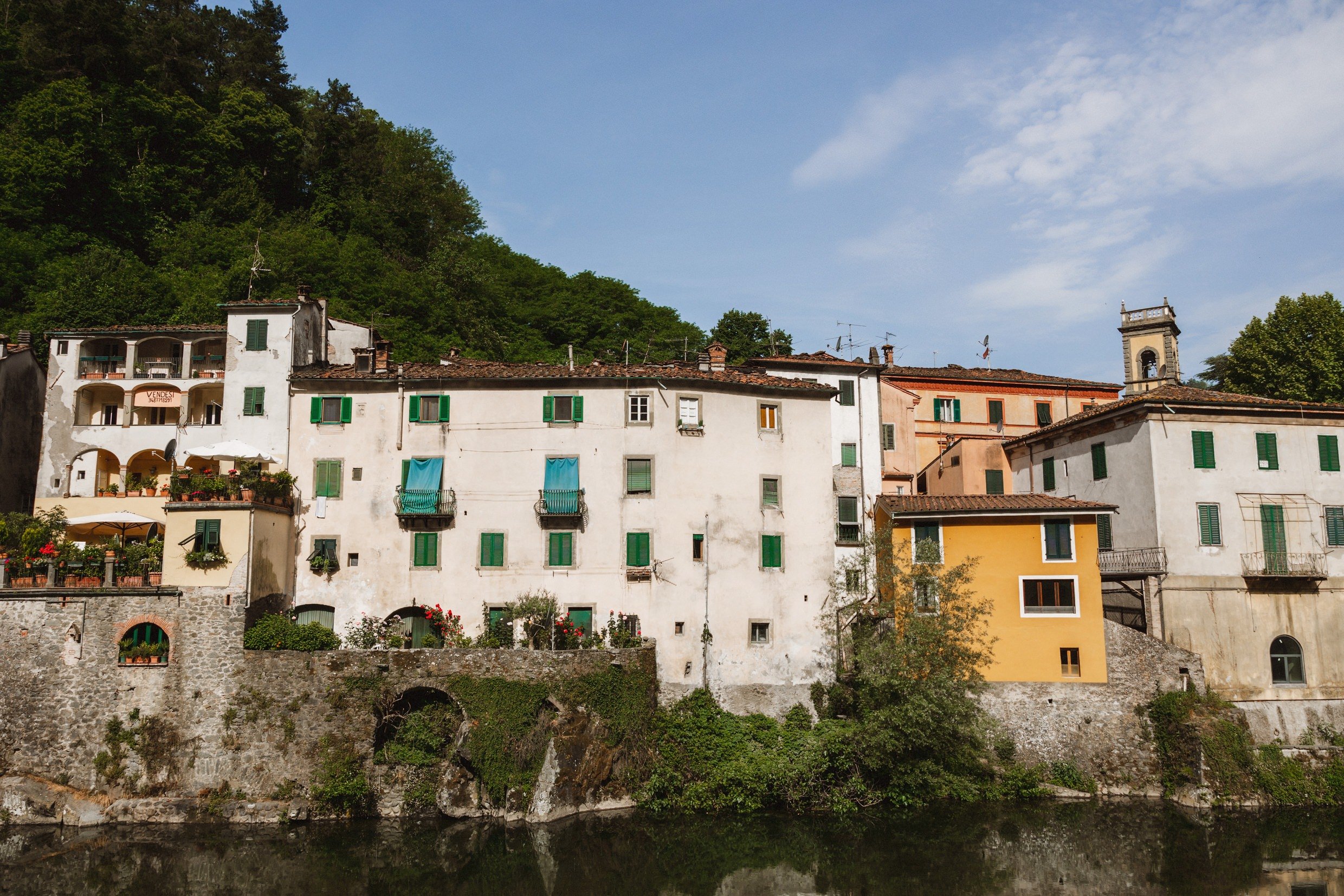 exterior view of old buildings on the banks of the river lima in bagni di lucca tuscany before italian destination wedding 