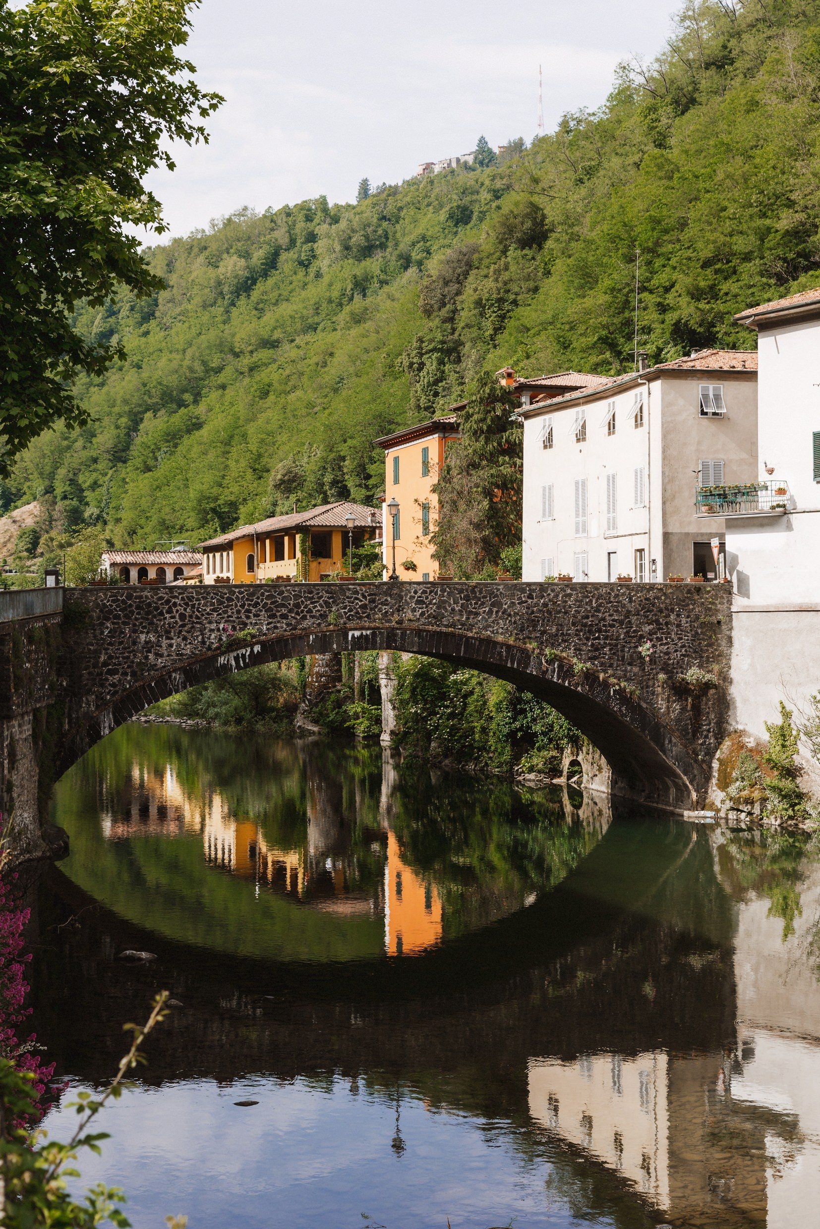 exterior view of old buildings and bridge on the banks of the river lima in bagni di lucca tuscany before italian destination wedding