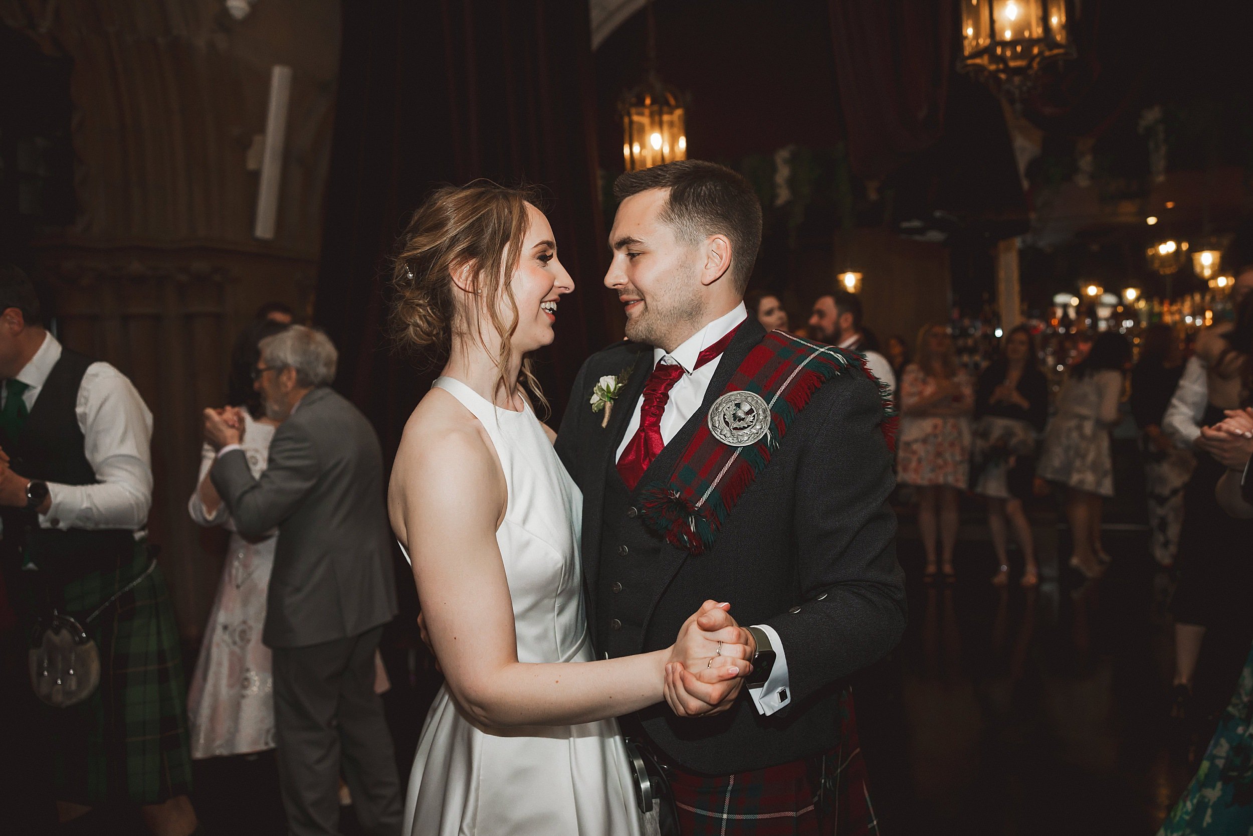 the bride and groom dance together in the auditorium at the ghillie dhu edinburgh wedding venue by documentary wedding photographer edinburgh