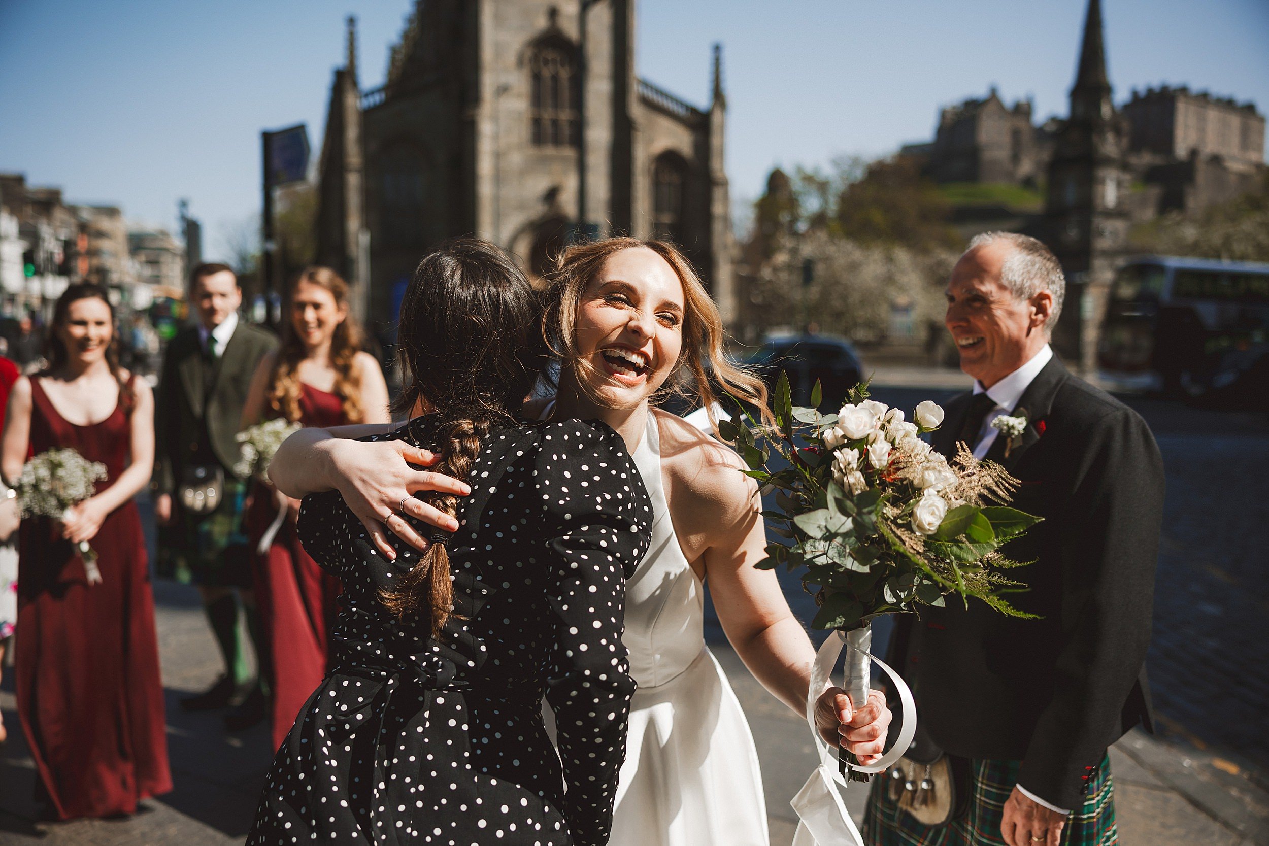 reportage shot of the bride greeting guests outside the ghillie dhu edinburgh wedding venue in scotland by documentary wedding photographer edinburgh