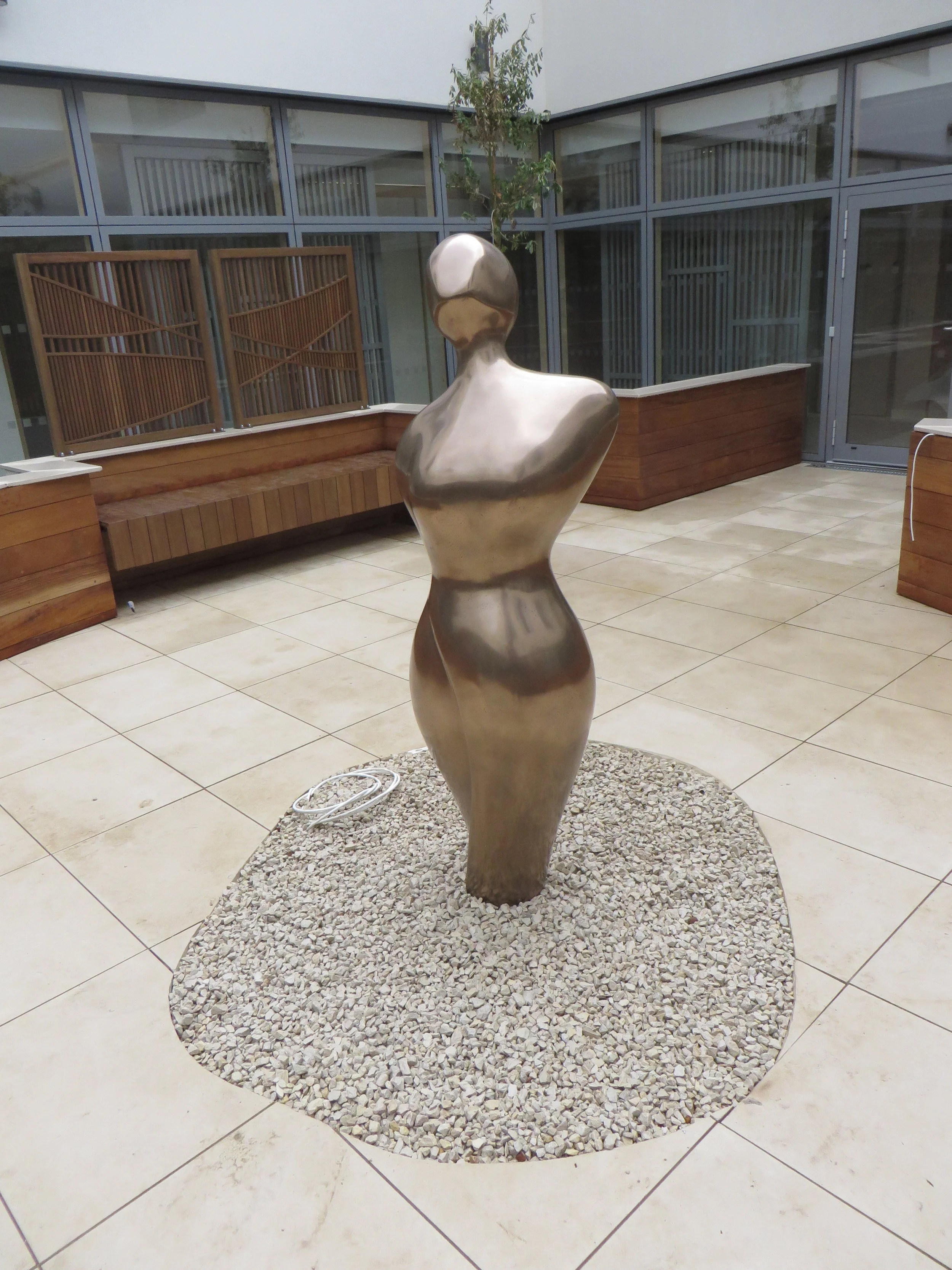 Henry Moore style, outdoor sculpture, powder coated in bronze