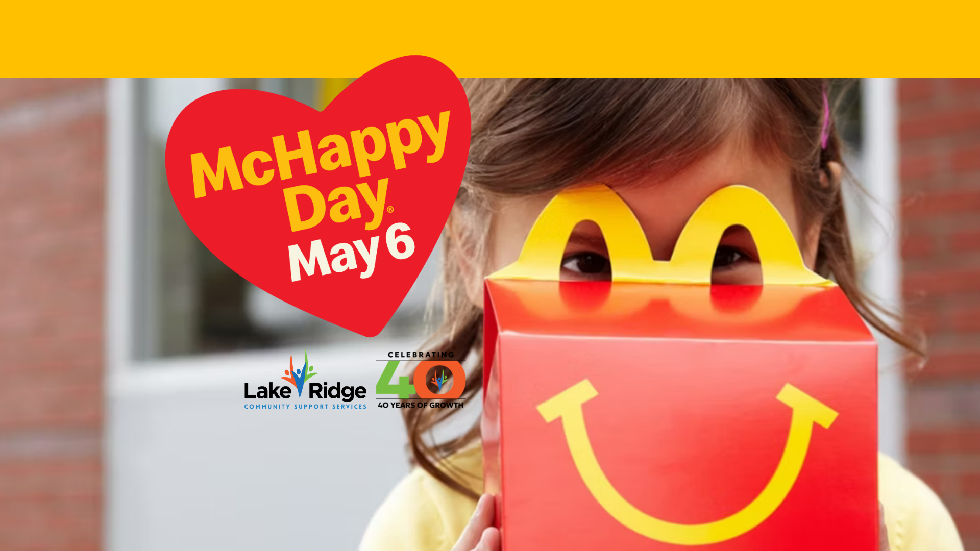 McHappy Day May 6. Image of little girl peaking over a happy meal container.