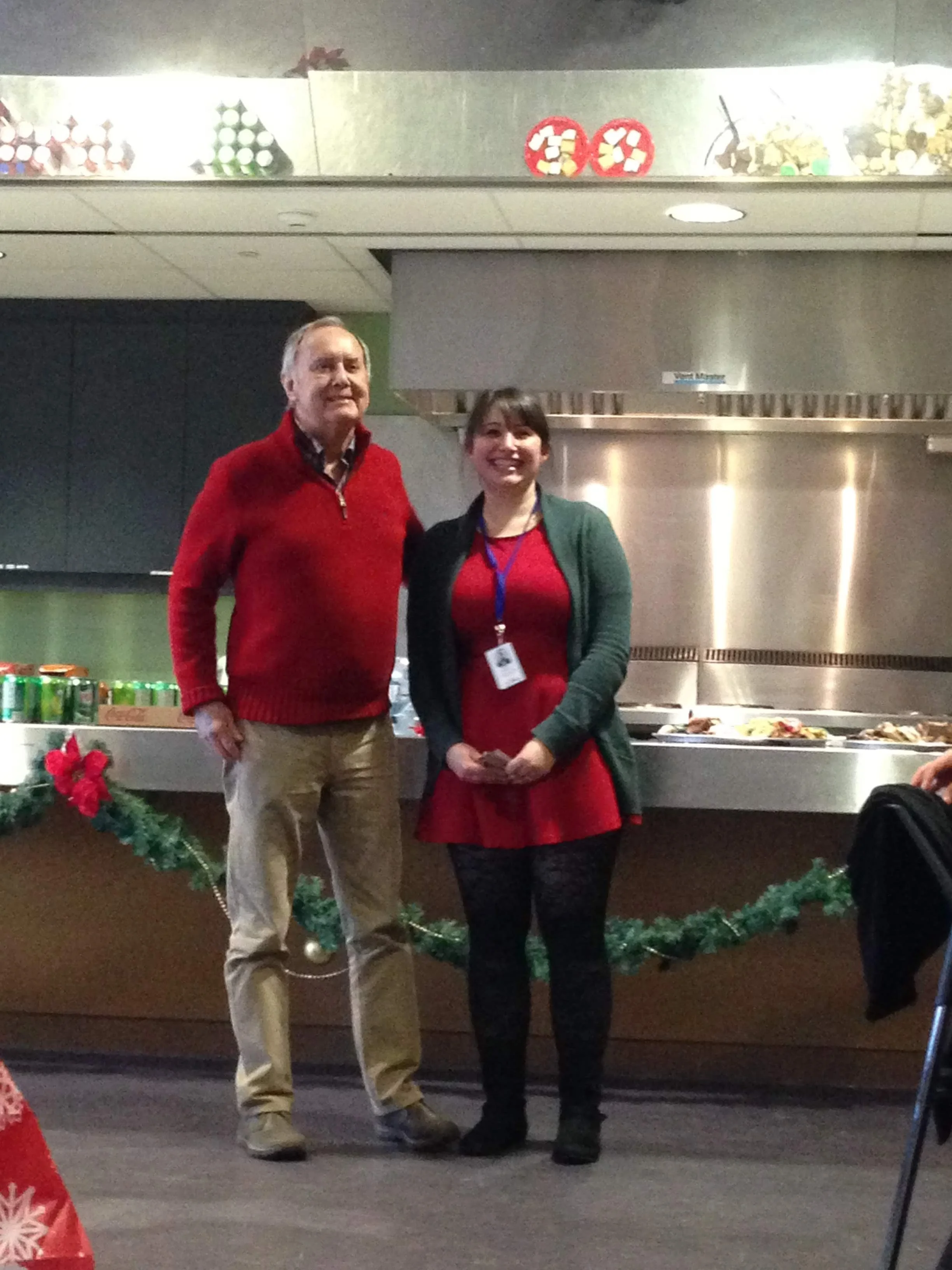 Jim Reaume awarding staff member Nicole with an award his retirement.