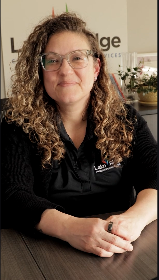 Renee Hacker smiling at the camera in her office.