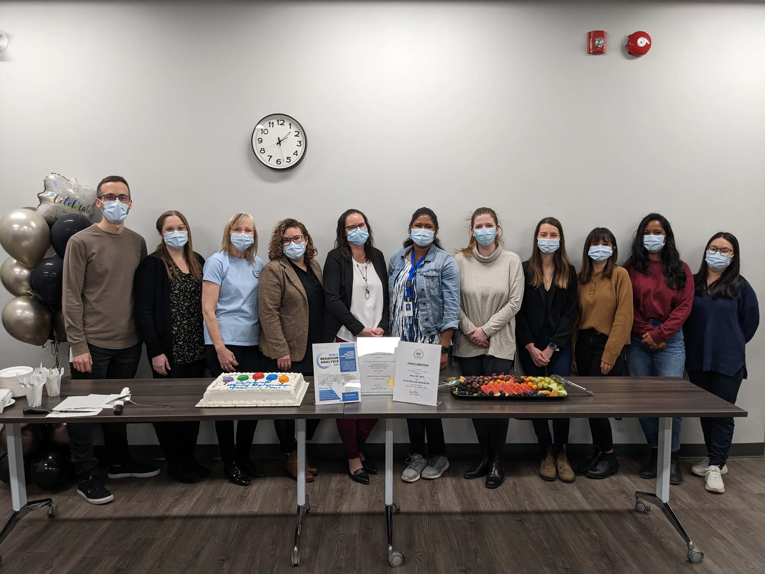 Group shot of team and Cake celebrating World Behaviour Analysis Day in 2023.