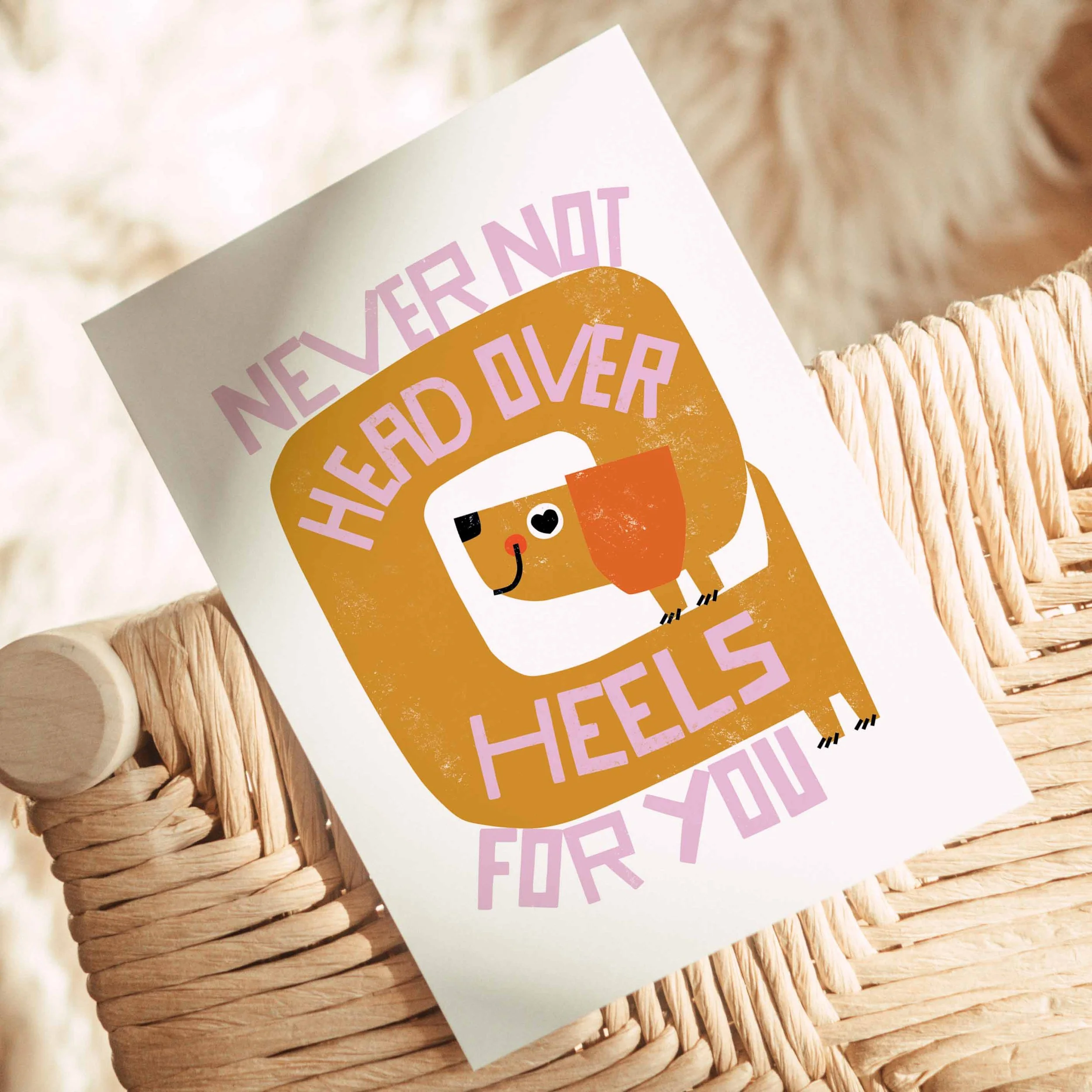 A greeting card with a cartoon wiener dog and the message 'Never not headed over heels for you'