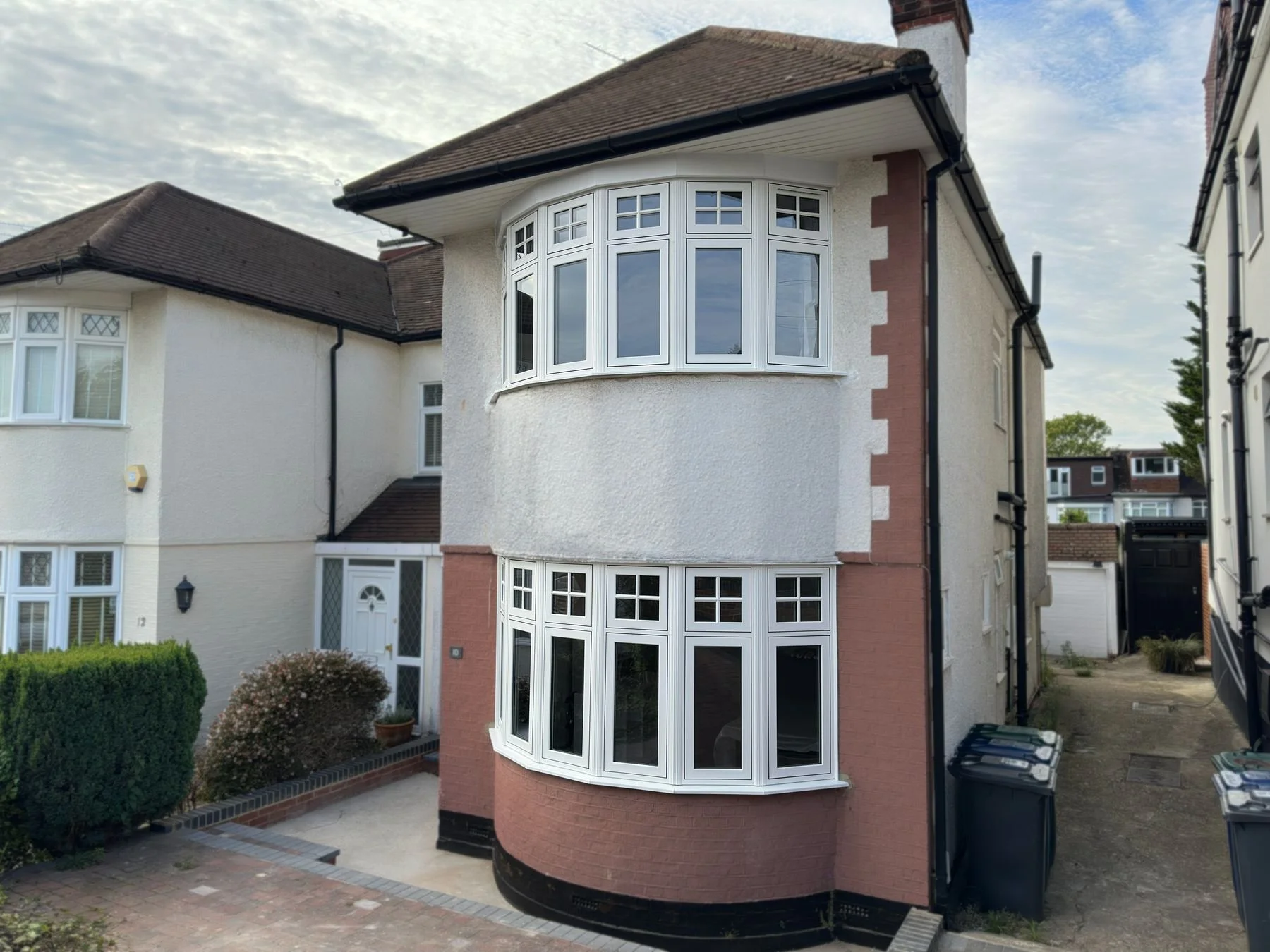 White uPVC bay windows on a rendered 1930s semi detached house, installed by Oakwood Windows