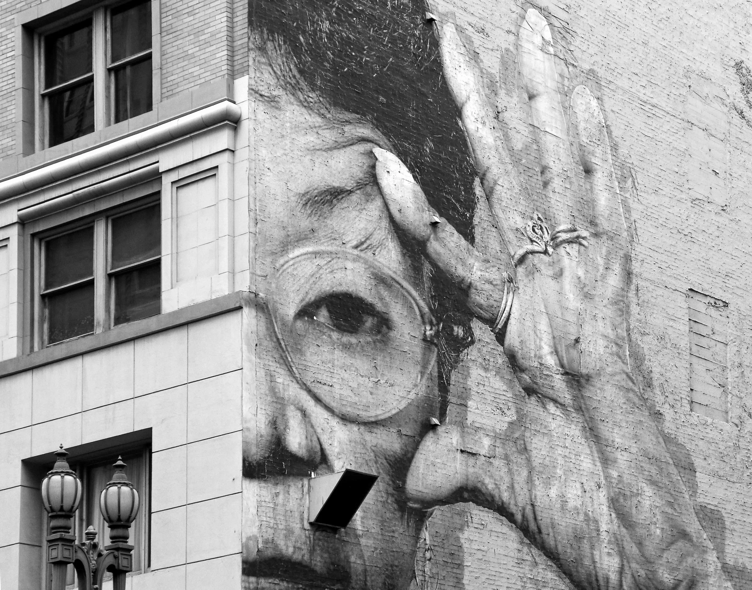 WomanEyesOpenWallDowntown.jpeg