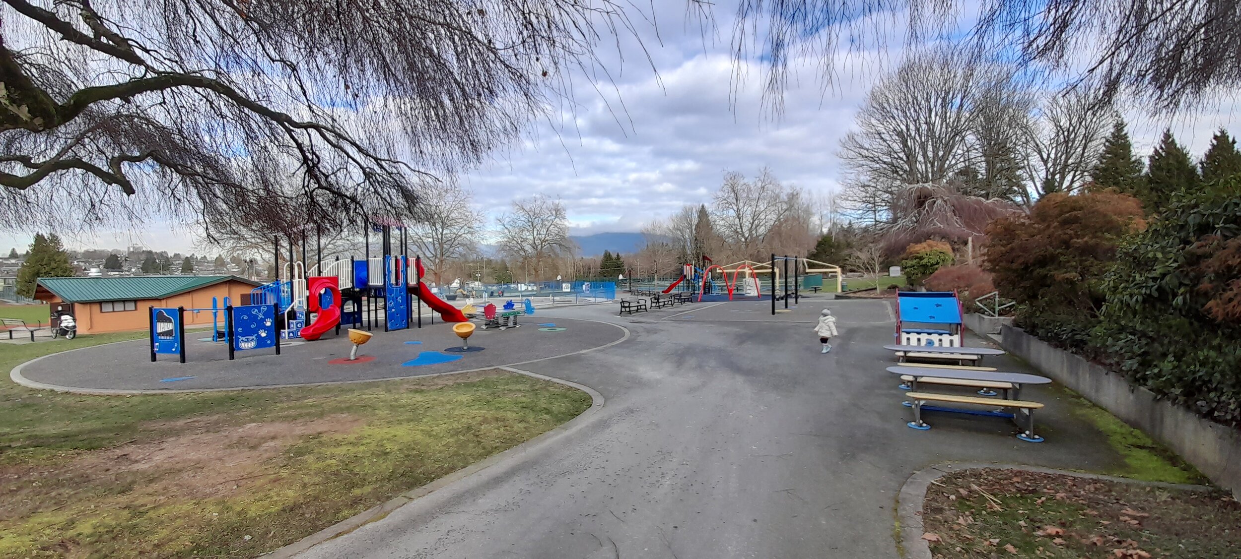 View of the playground, public washrooms, and trees