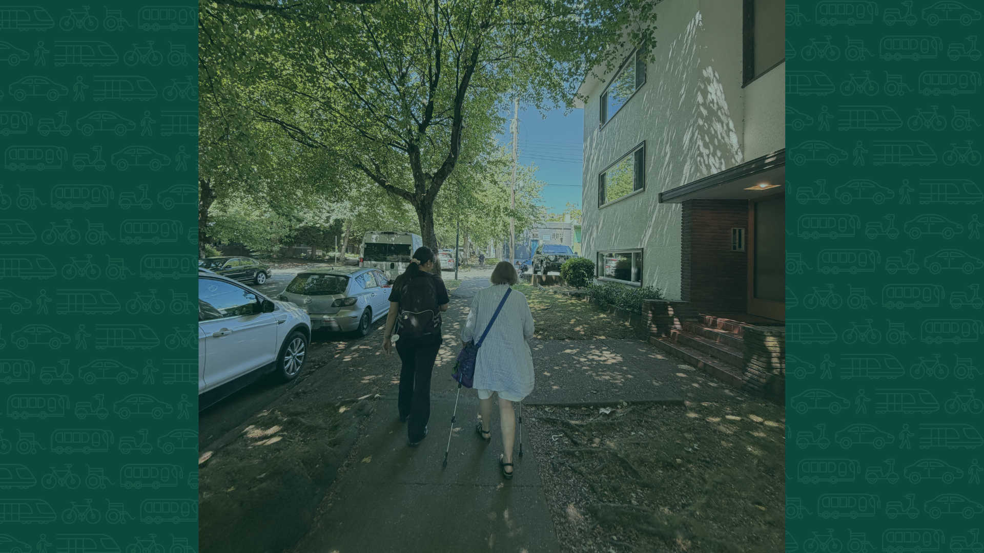 Image a younger person and an older person walking on a residential sidewalk
