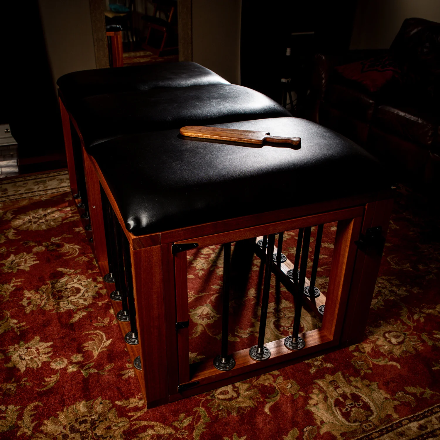 Padded play furniture and a wooden paddle at the Portal