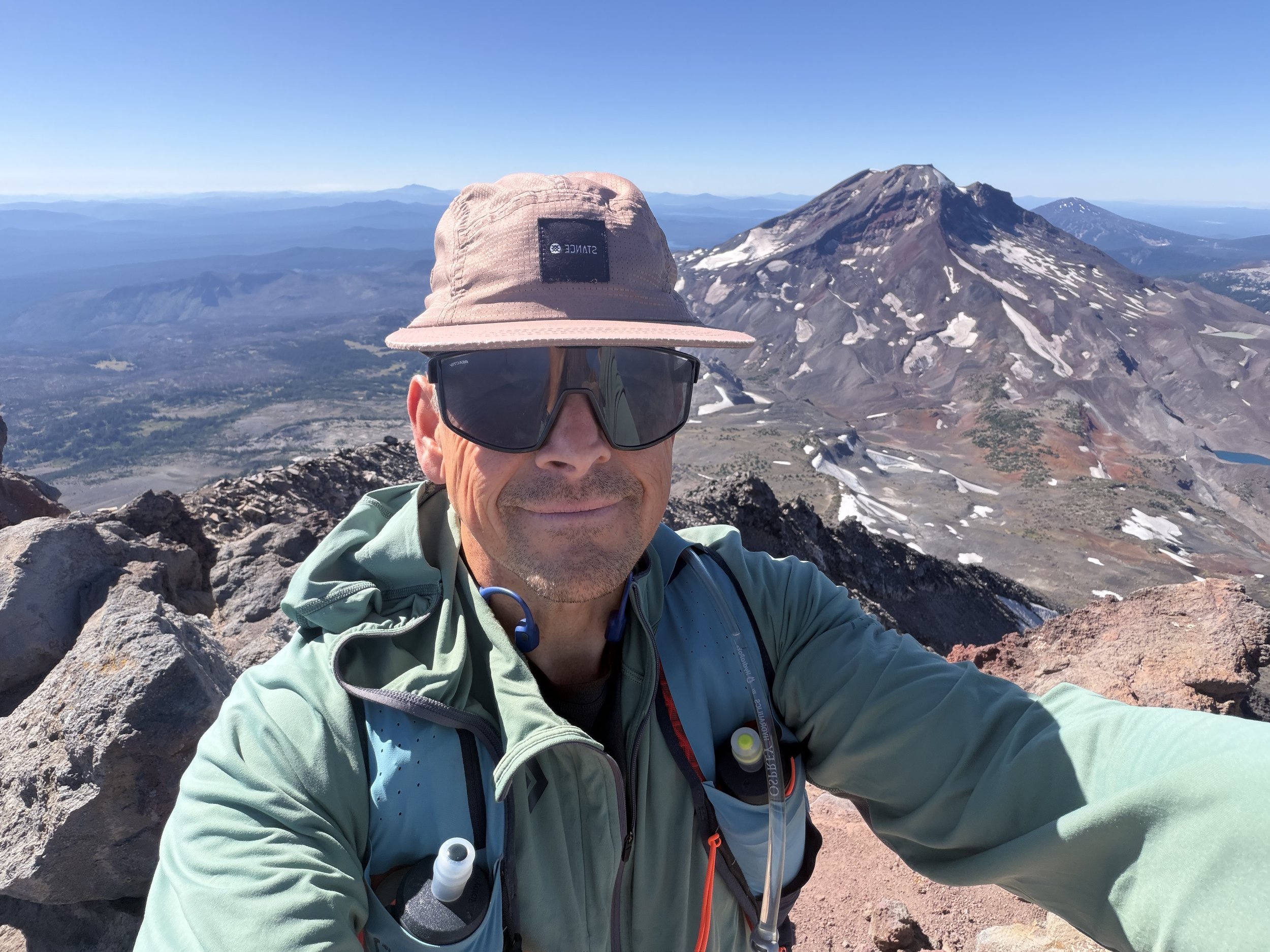 Photo of Three Sisters Guide, Dane Brinkley hiking with South Sister in the background