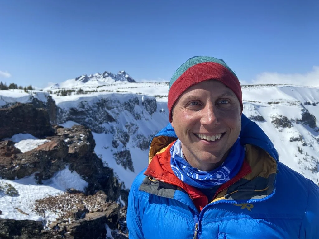 Photo of Guide, Elliott Reed with mountains in the background