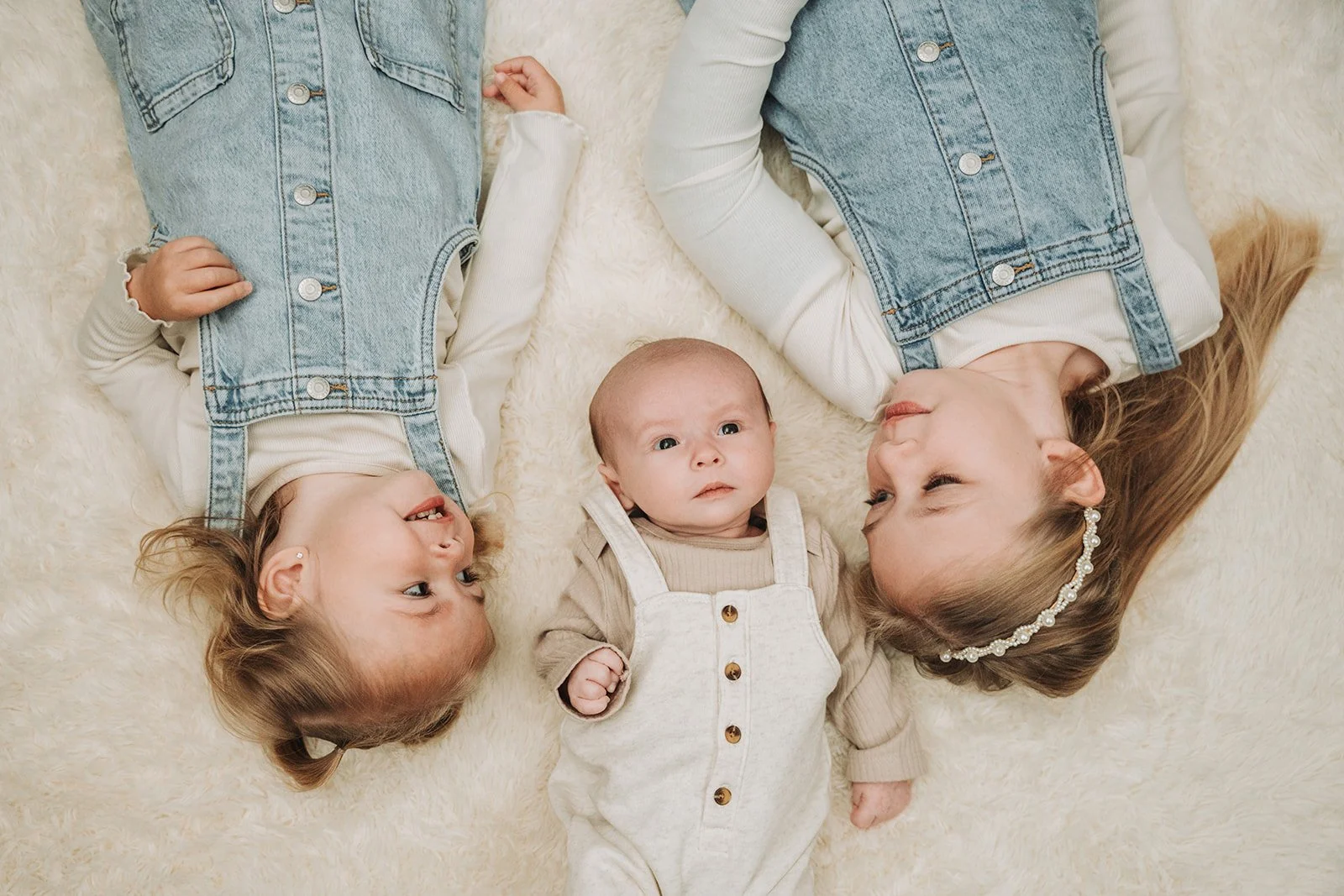 Siblings laying on floor together during a newborn family session in Curwensville PA.