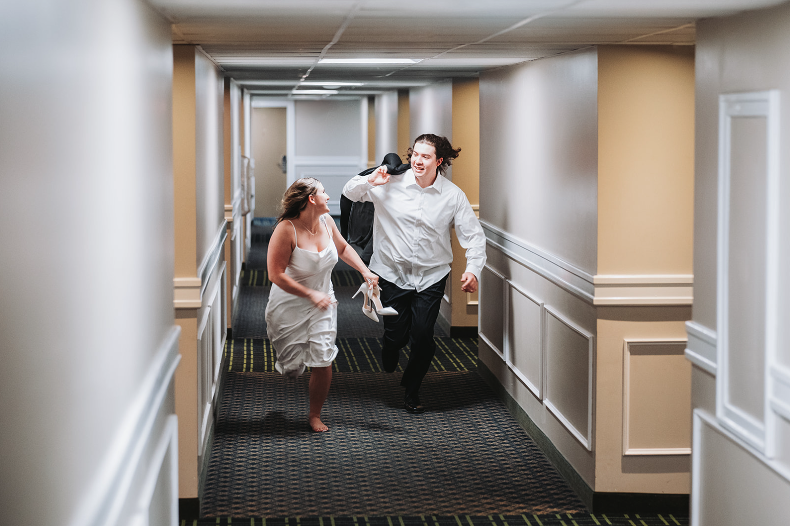 couple-running-hotel-hallway-altoona.png