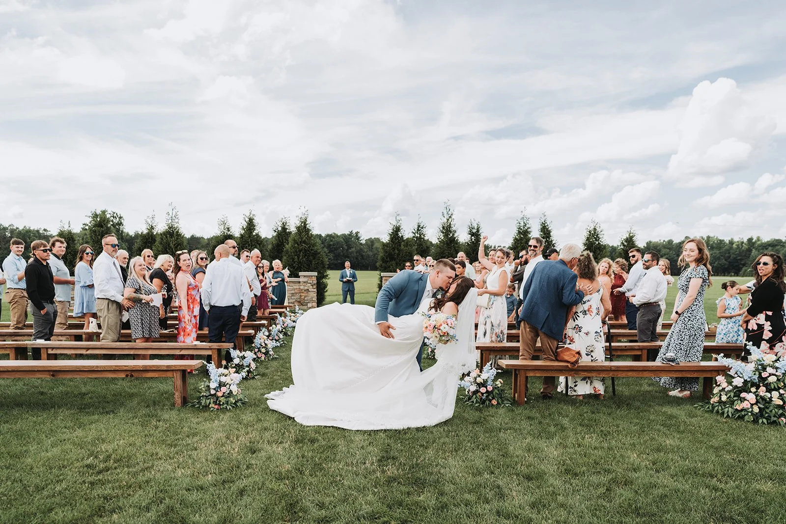 Bride and groom sharing a dip kiss during Pennsylvania wedding ceremony at Tuck'd Inn Farm