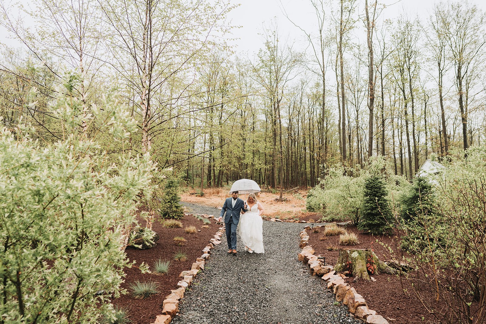 Rainy day umbrella portraits at Rolling Rails Lodge spring wedding Central Pennsylvania.