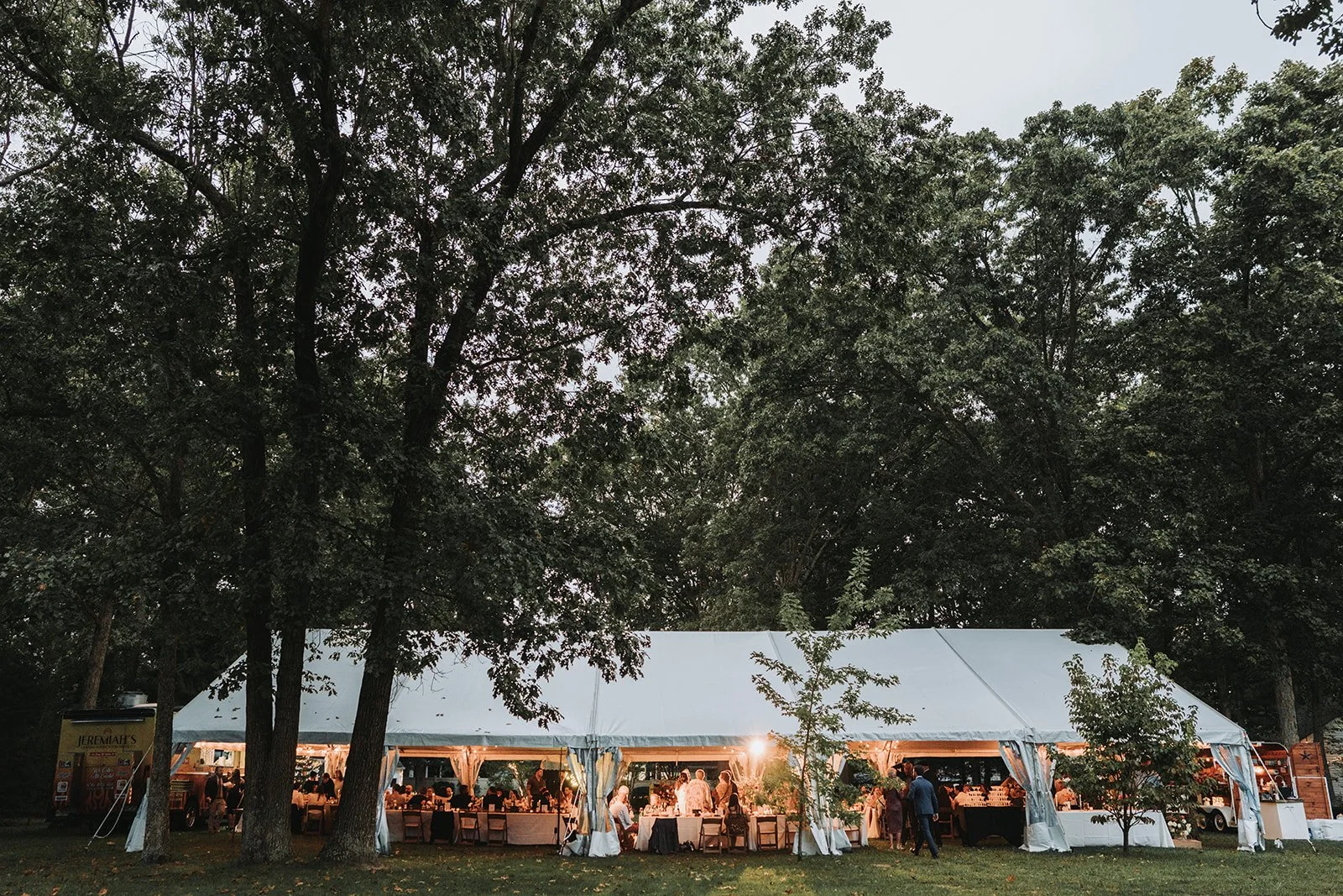 Intimate backyard wedding reception under a tent.