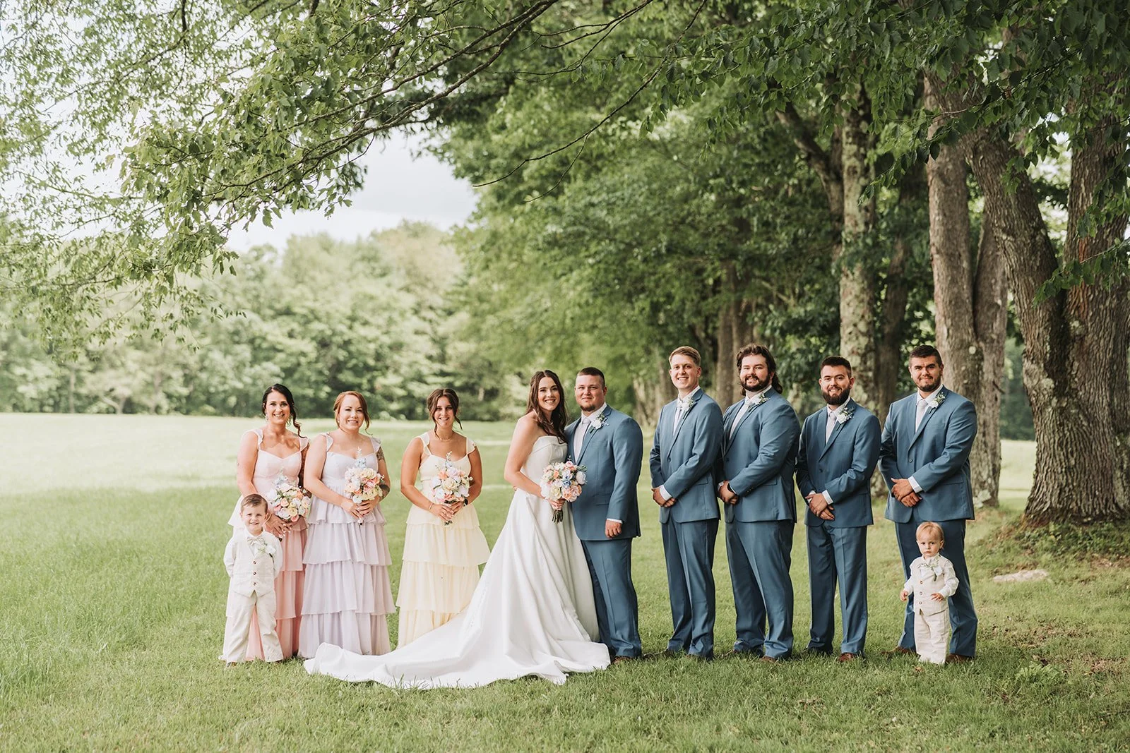 Pre ceremony portraits along tree line at Tuck'd Inn Farm wedding in Pennsylvania.