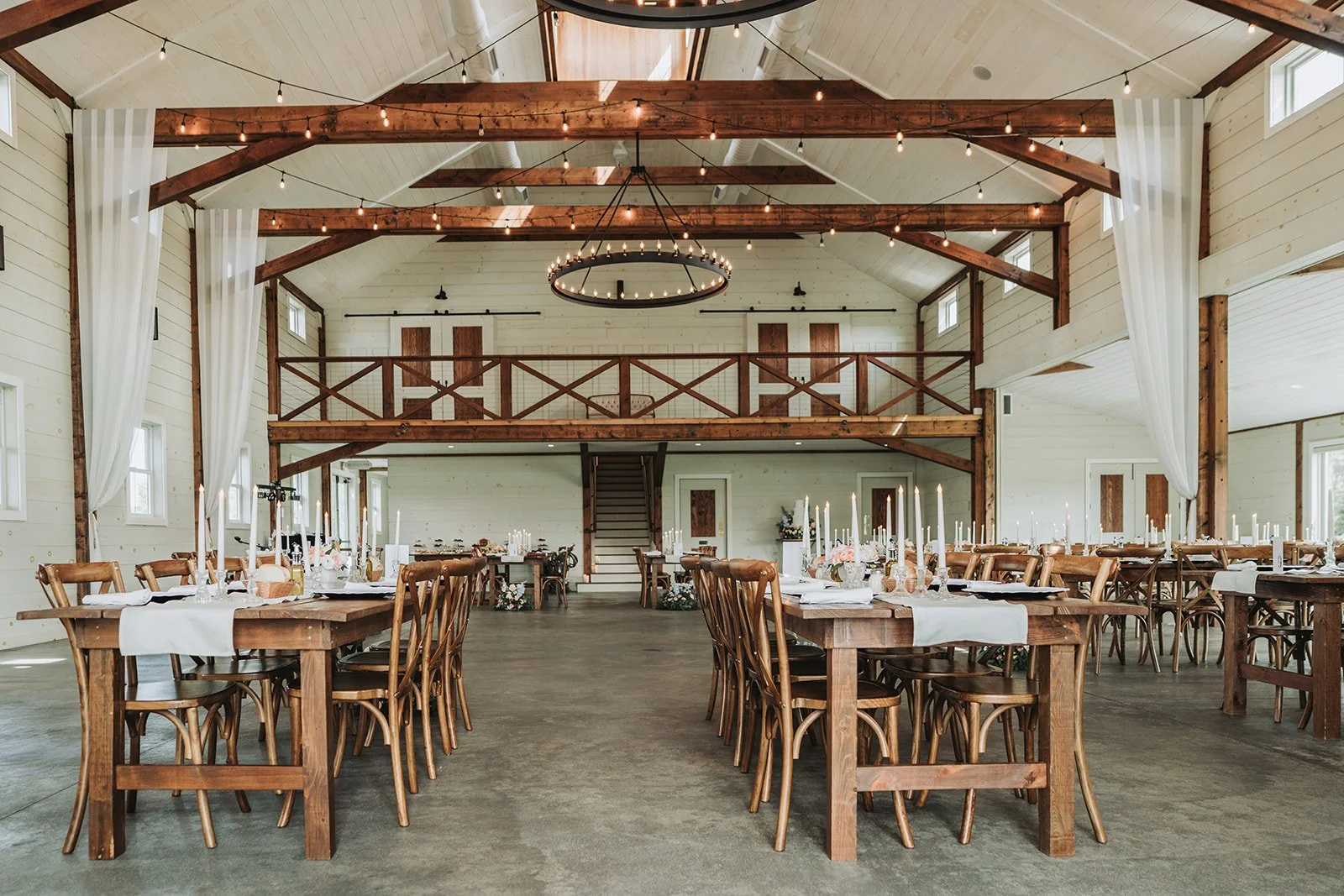 Untouched reception detail photos inside the modern barn at Tuck'd Inn Farm.