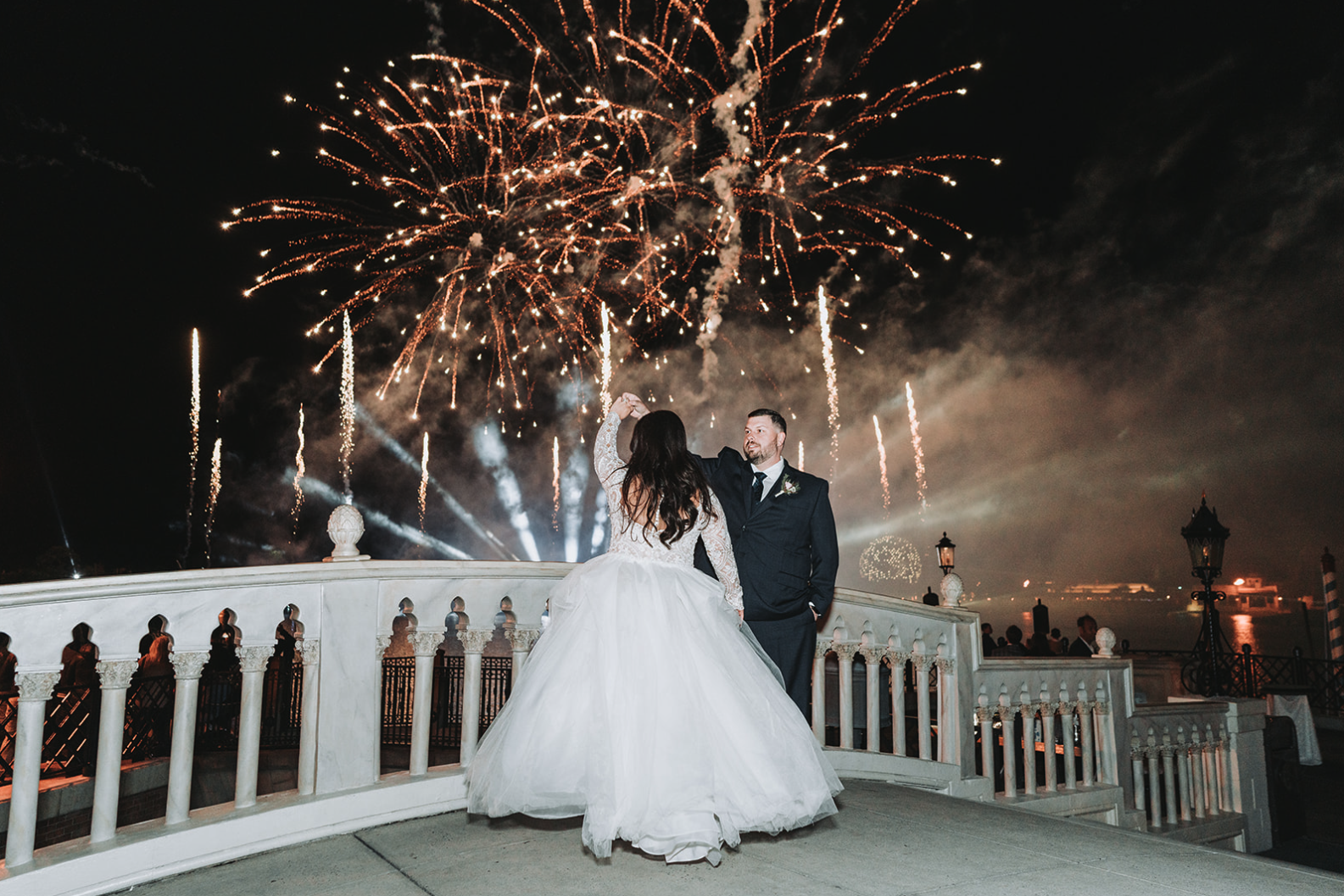 EPCOT fireworks over World Showcase Lagoon during Italy Isola wedding reception.