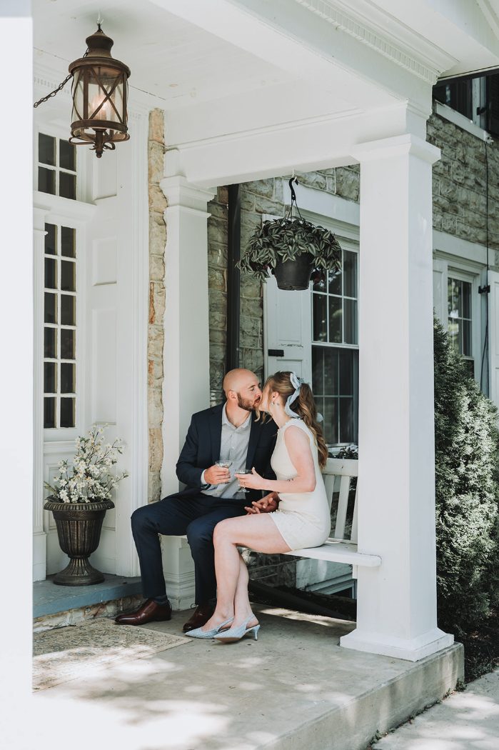 engaged-couple-kiss-porch.png