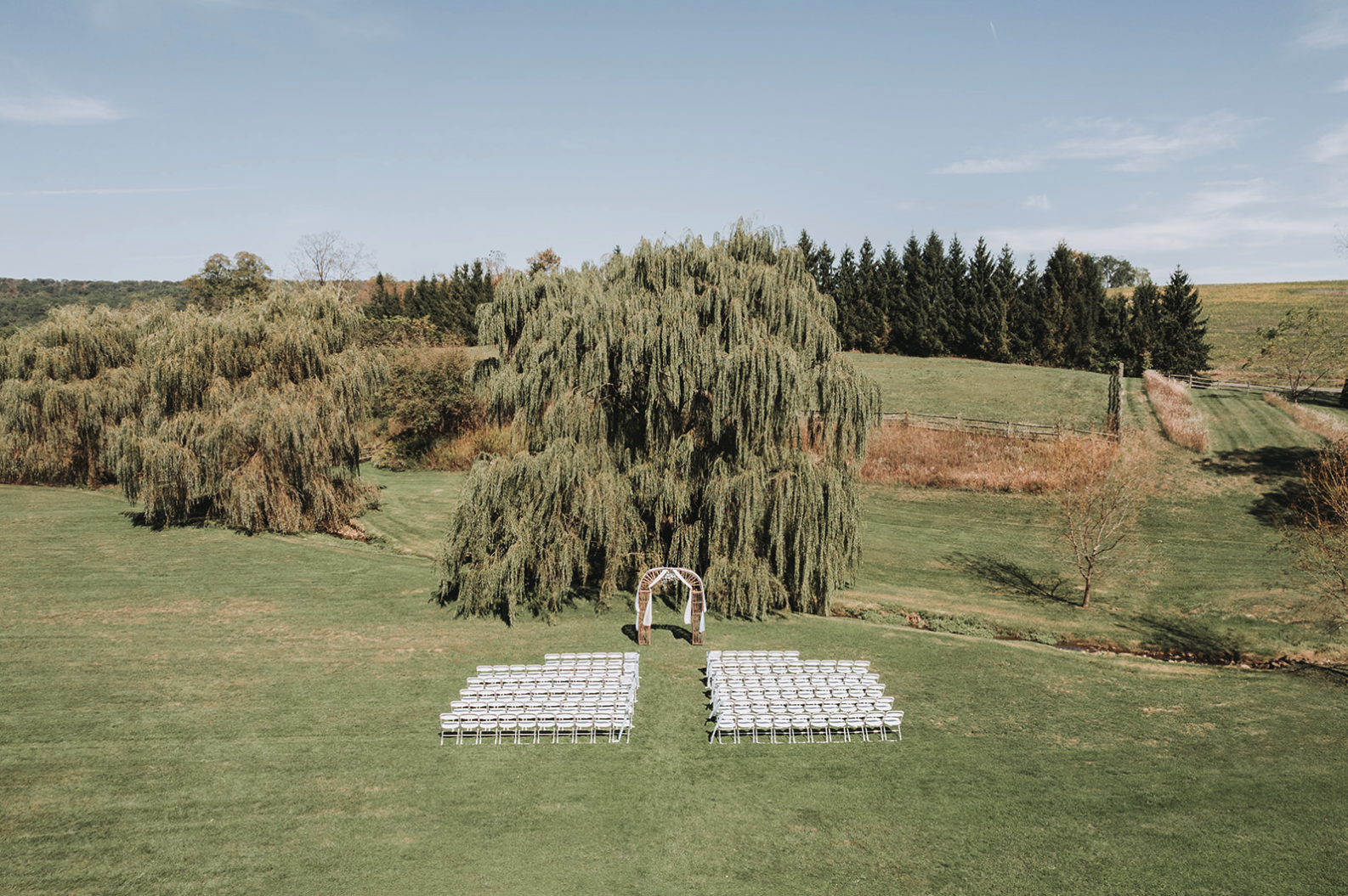 Fall wedding ceremony under the willow tree at Gillbrook Farms.