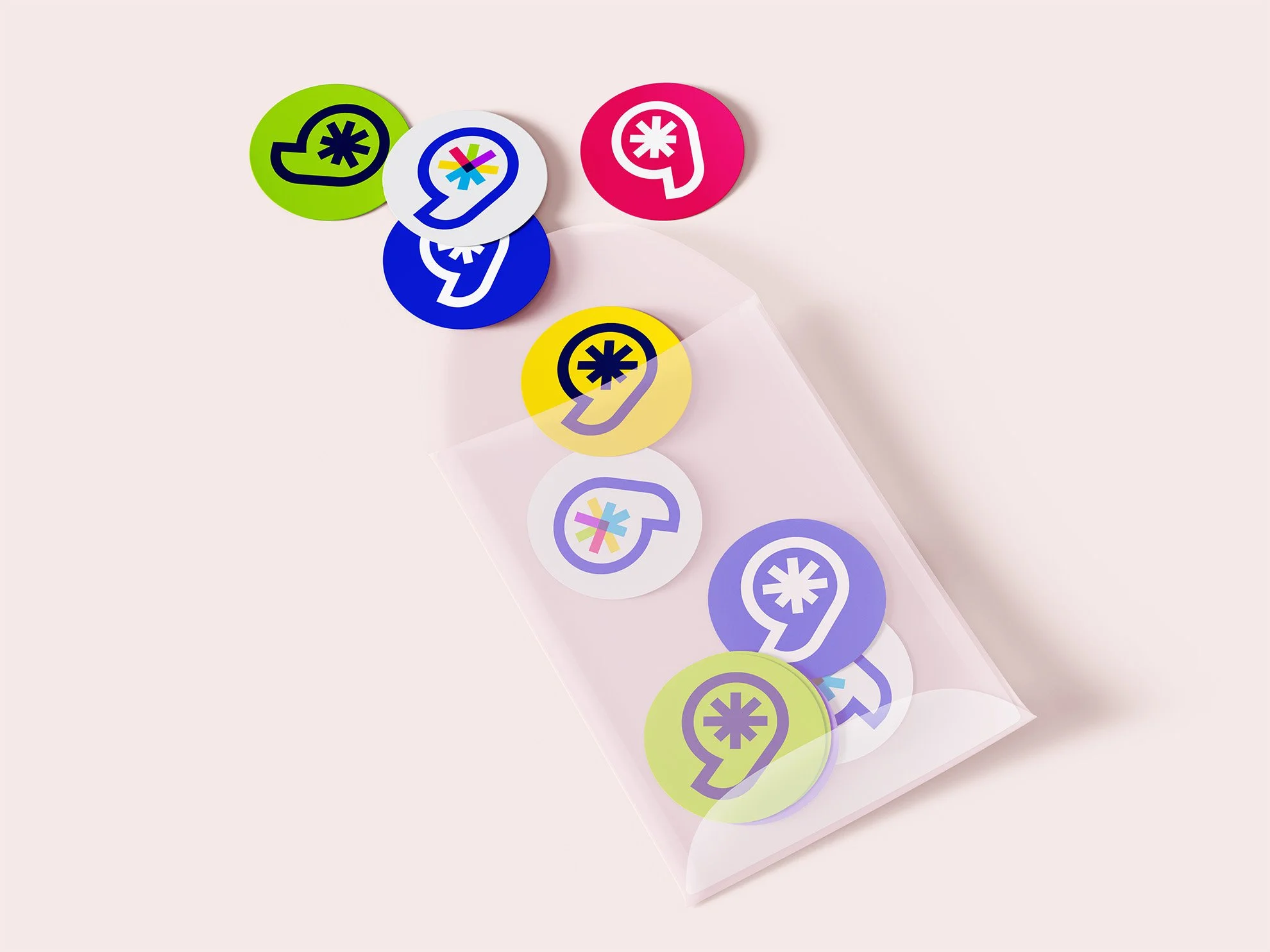Circle stickers showing the Learning League logomark in various colors spill out of a clear envelope