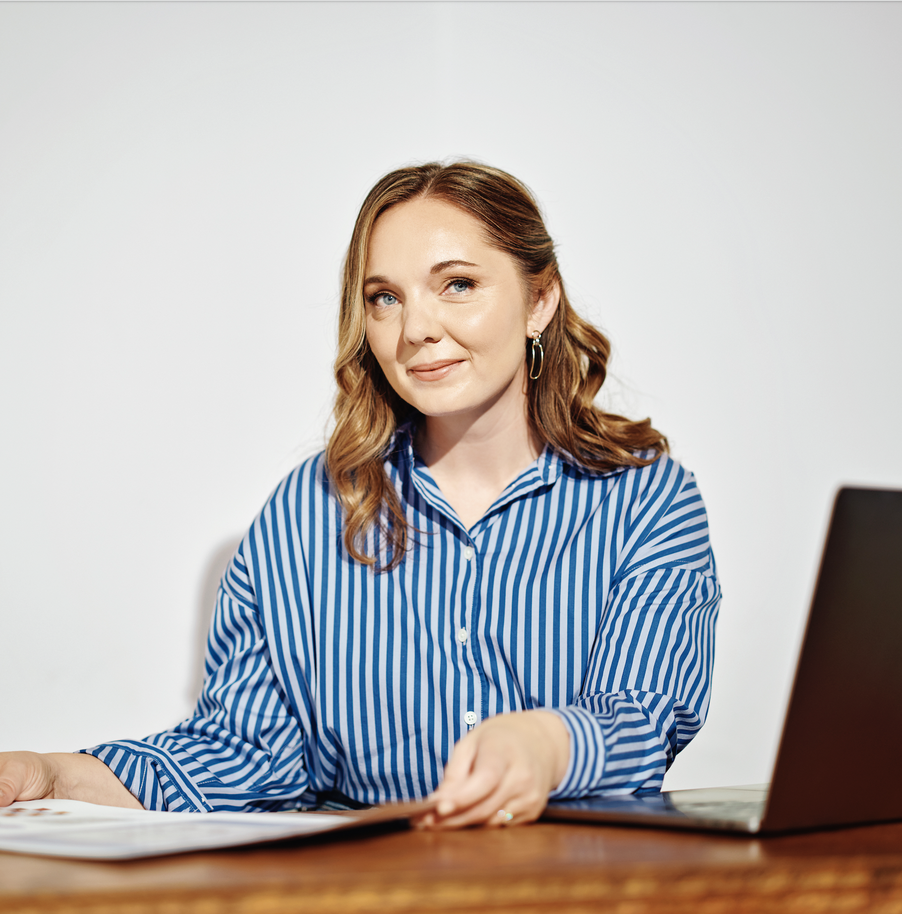 Chelsey Farris sits working at desk with print-outs in her hands