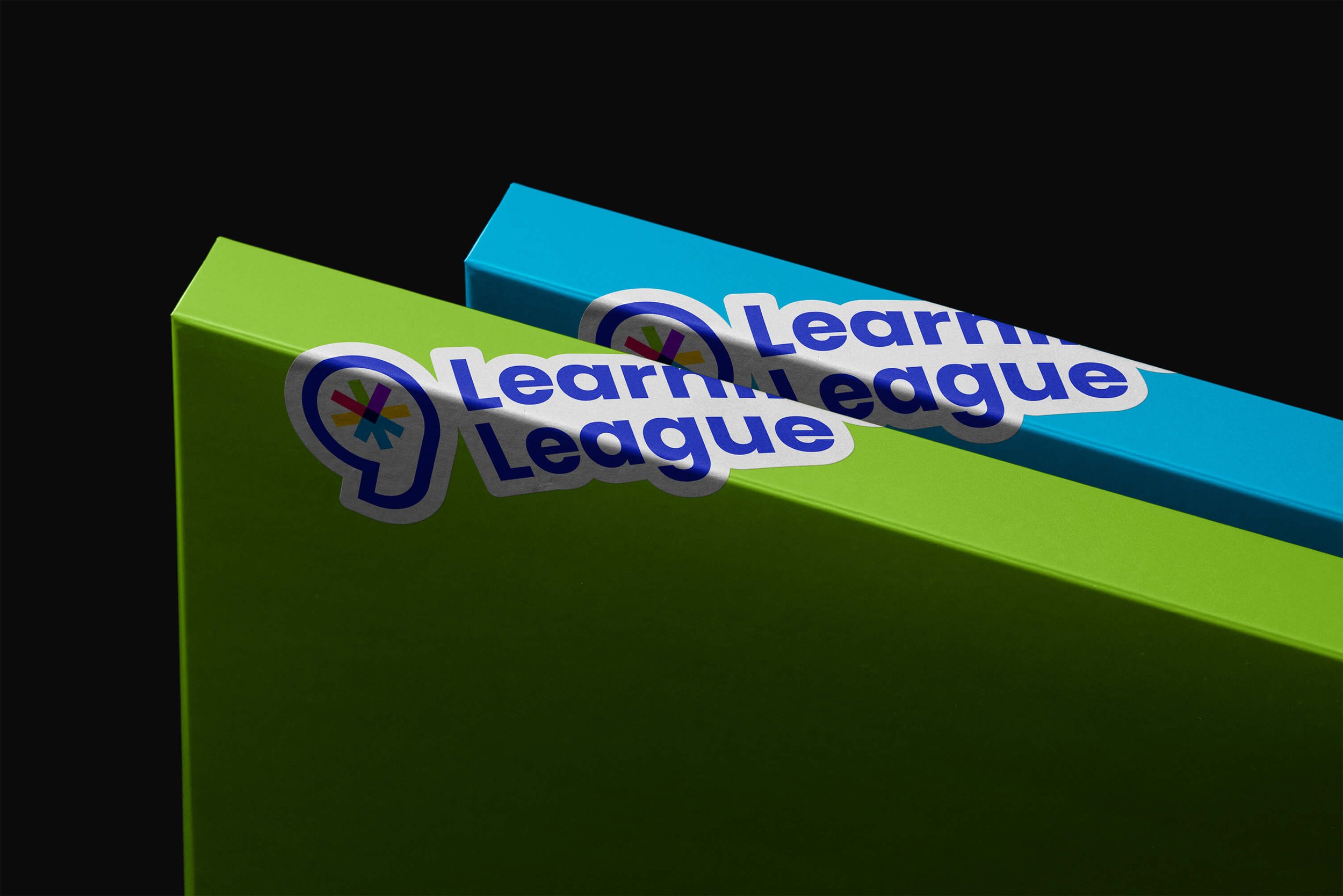 Learning League stickers are stuck on two binders